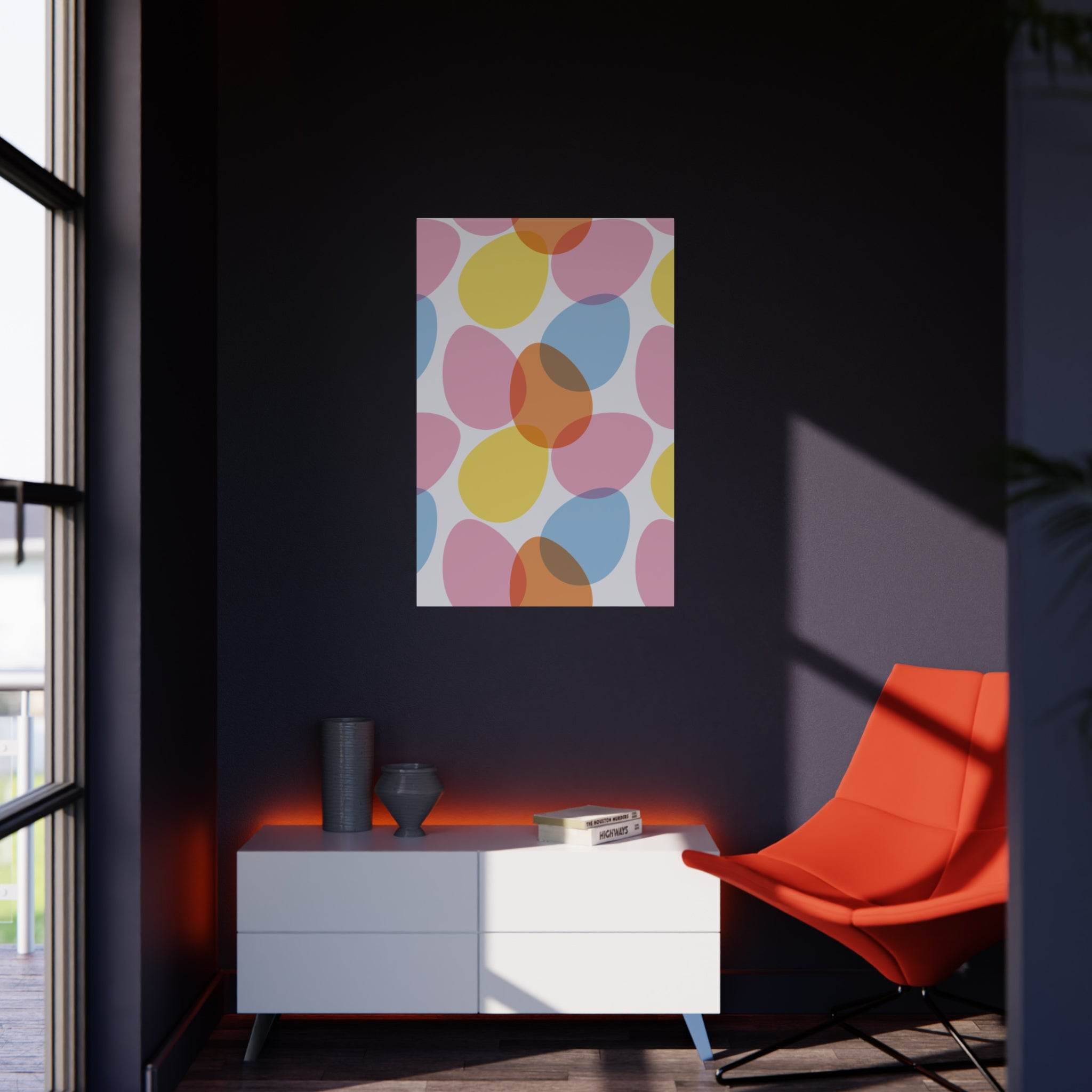 Colorful abstract print on eco-friendly foam board by Printify displayed on dark wall above modern white cabinet and orange chair