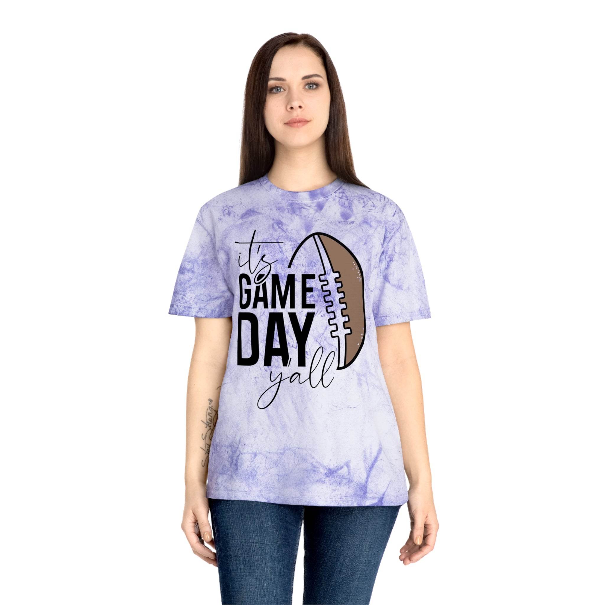 Woman wearing a Printify eco-friendly game day t-shirt with a purple tie-dye design and football graphic