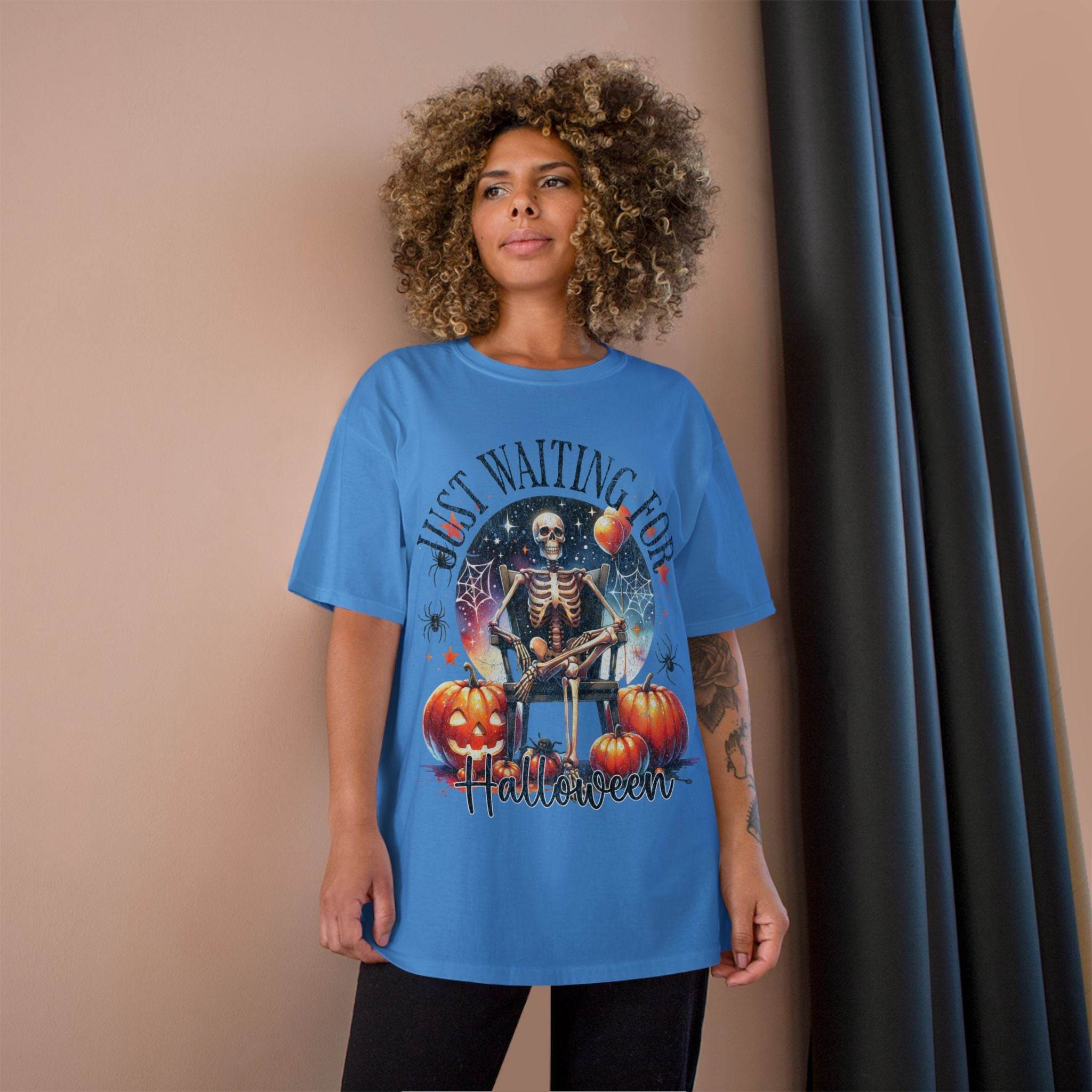Eco-friendly Halloween t-shirt by Printify with skeleton and pumpkins design on blue fabric