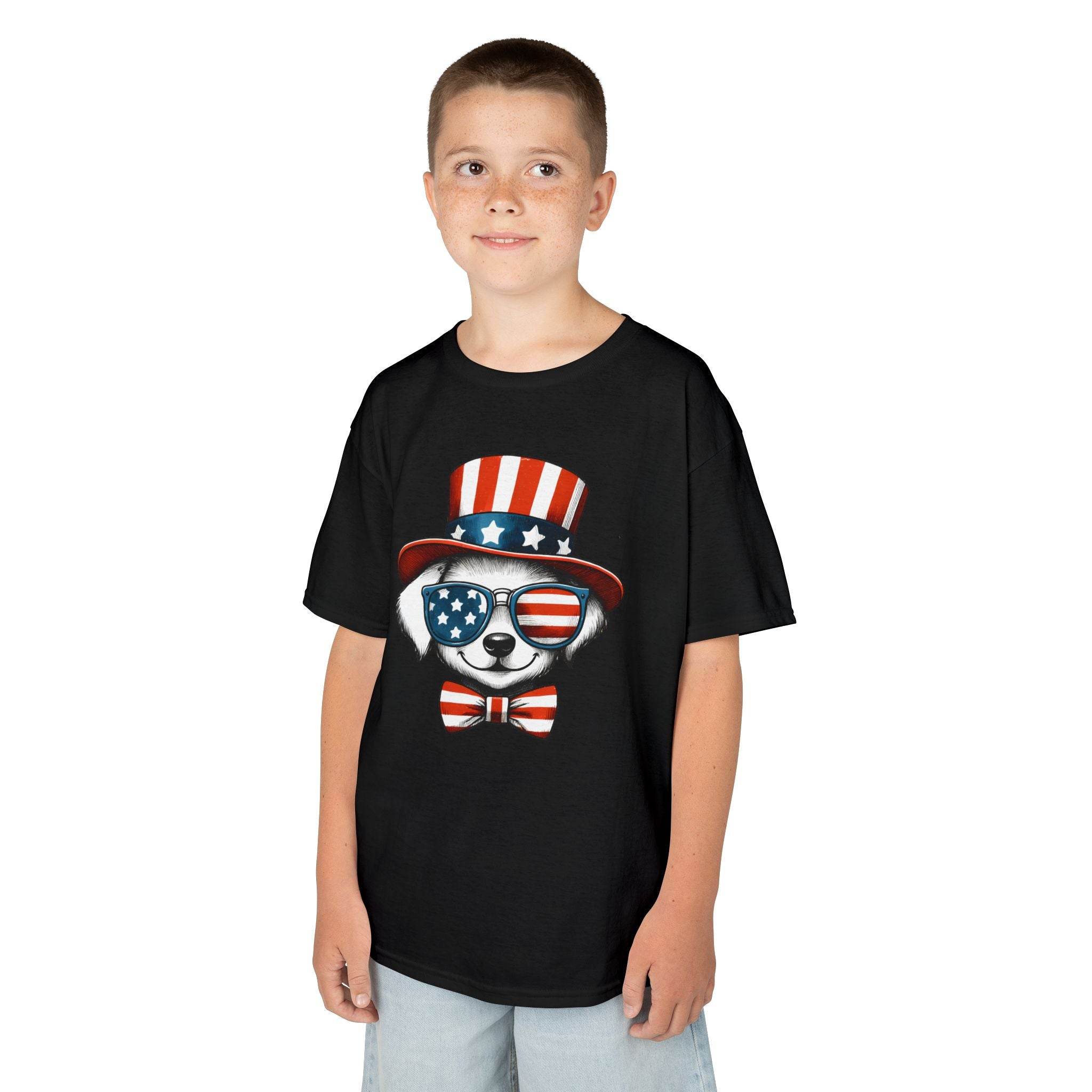 Boy wearing Printify black eco-friendly kids t-shirt with patriotic bear design in red white and blue
