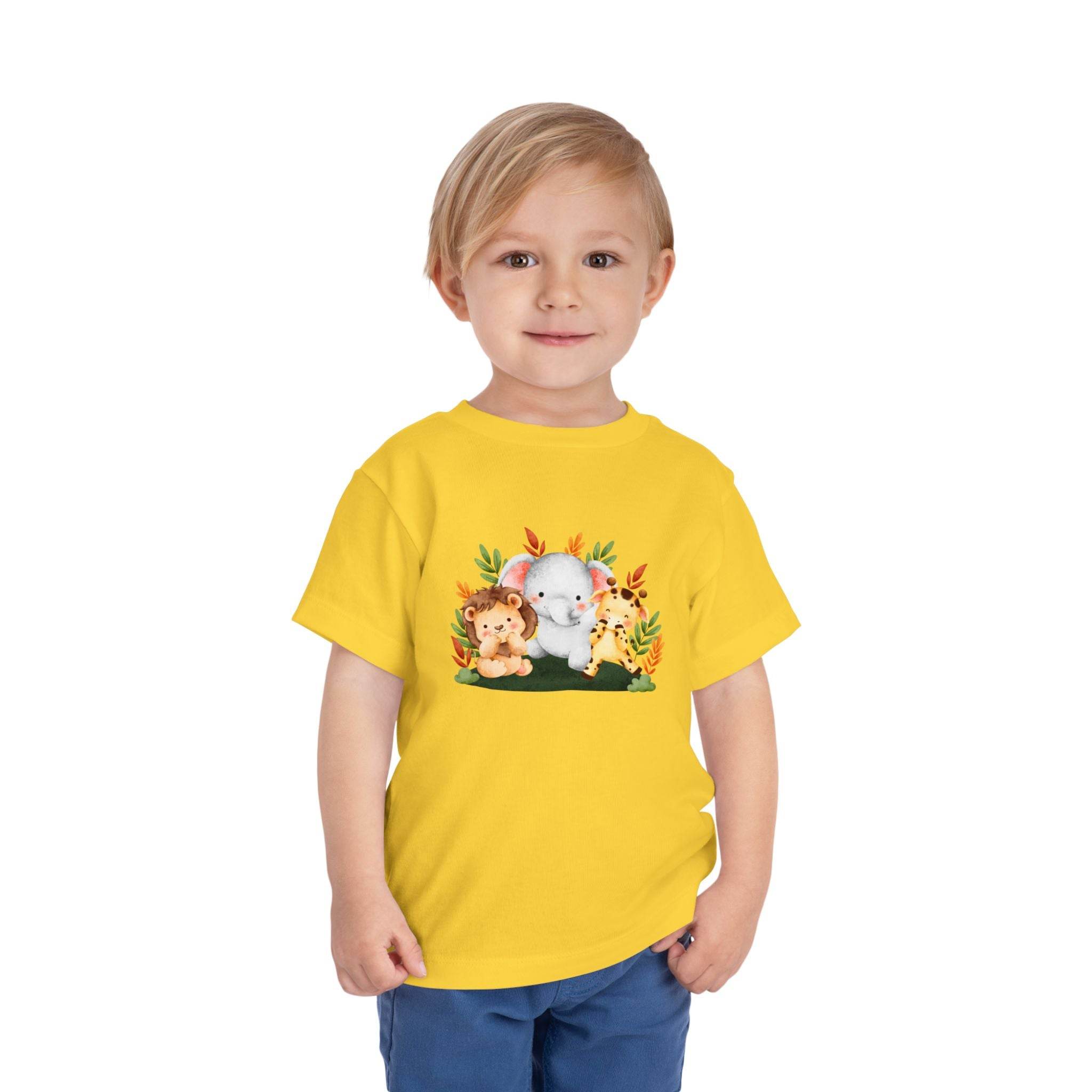 Printify eco-friendly kids t-shirt in yellow with cute animal graphic worn by a smiling toddler