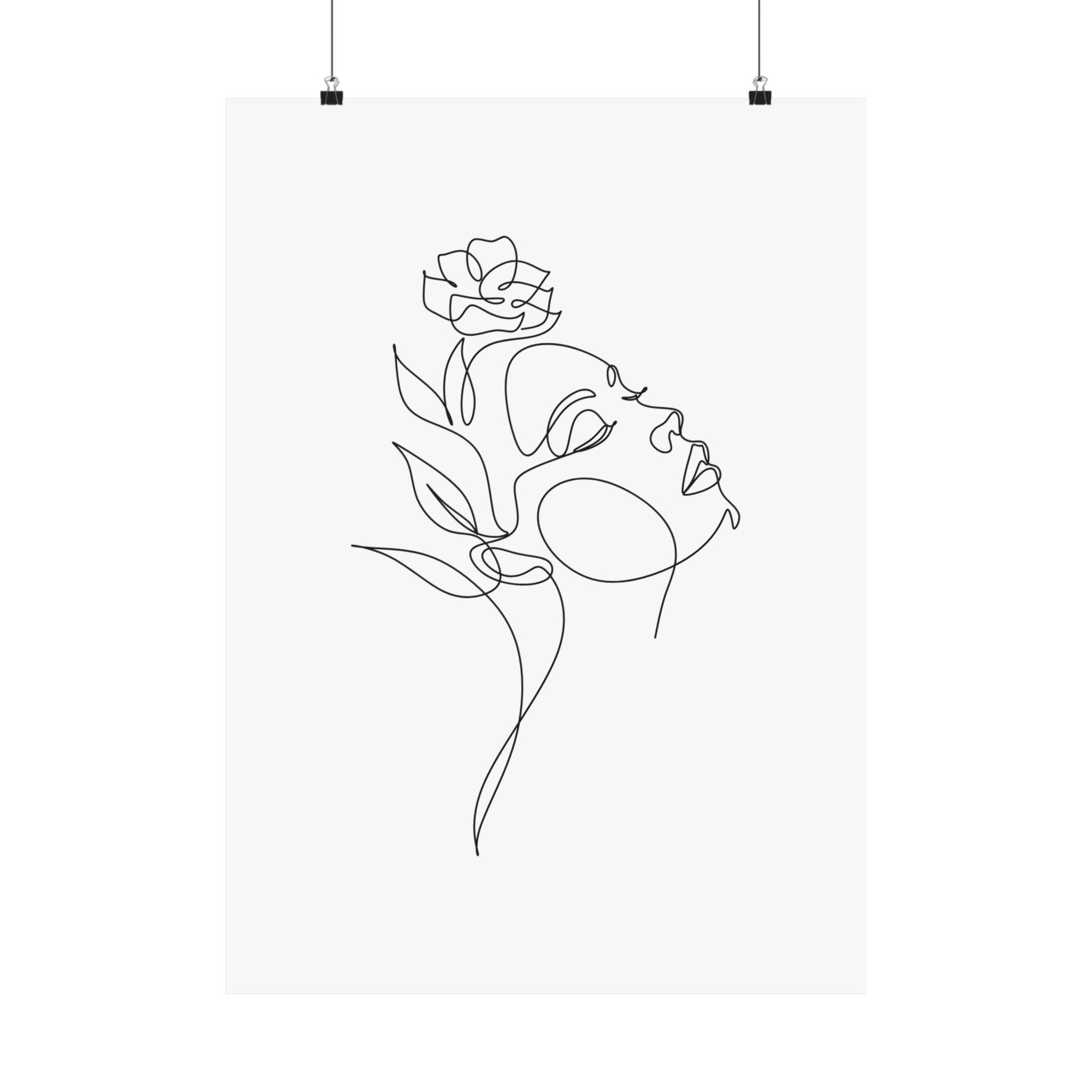 Minimalist line art floral design on eco-friendly matte posters by Printify hanging with clips