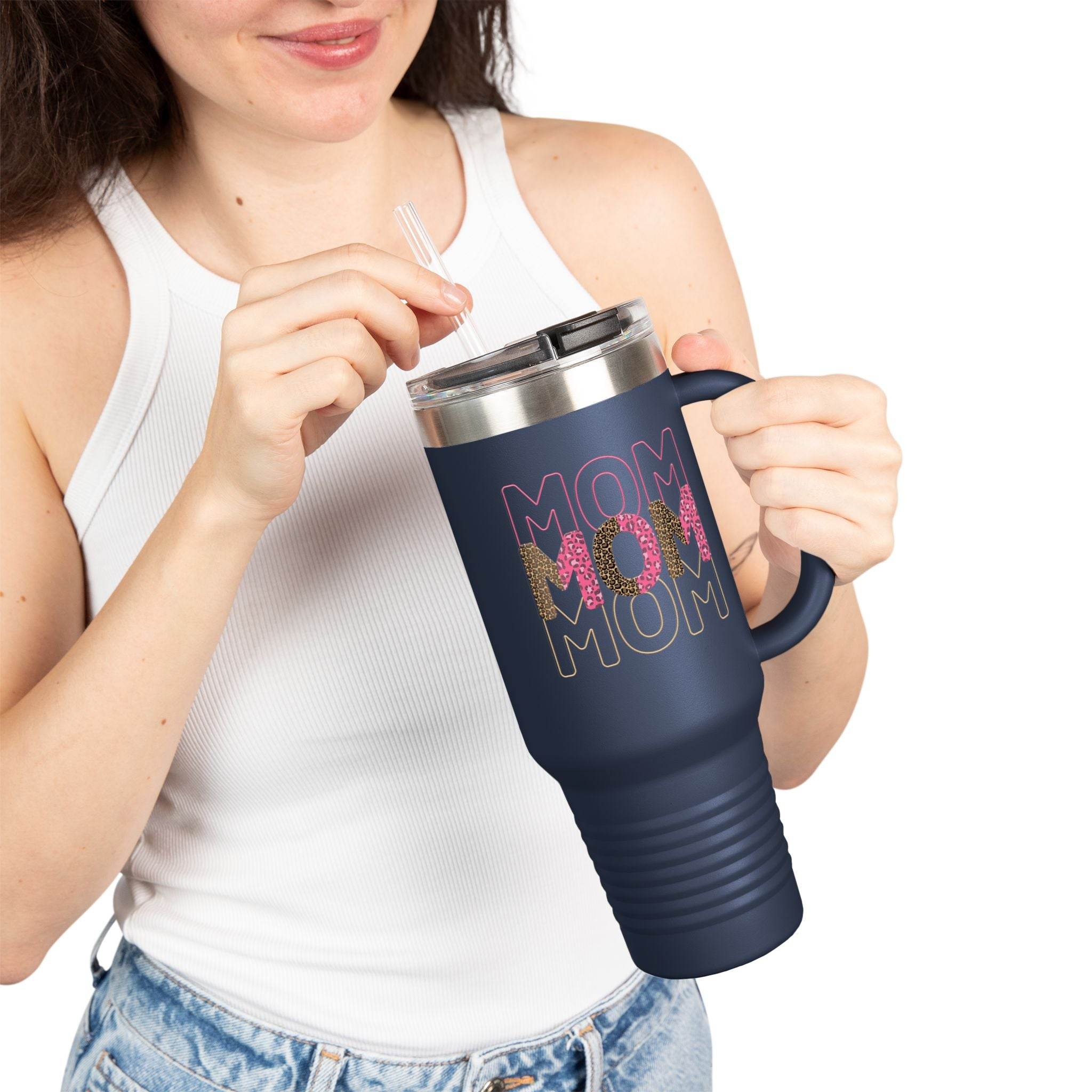 Printify eco-friendly mom travel mug in navy blue with triple MOM design held by woman in white tank top