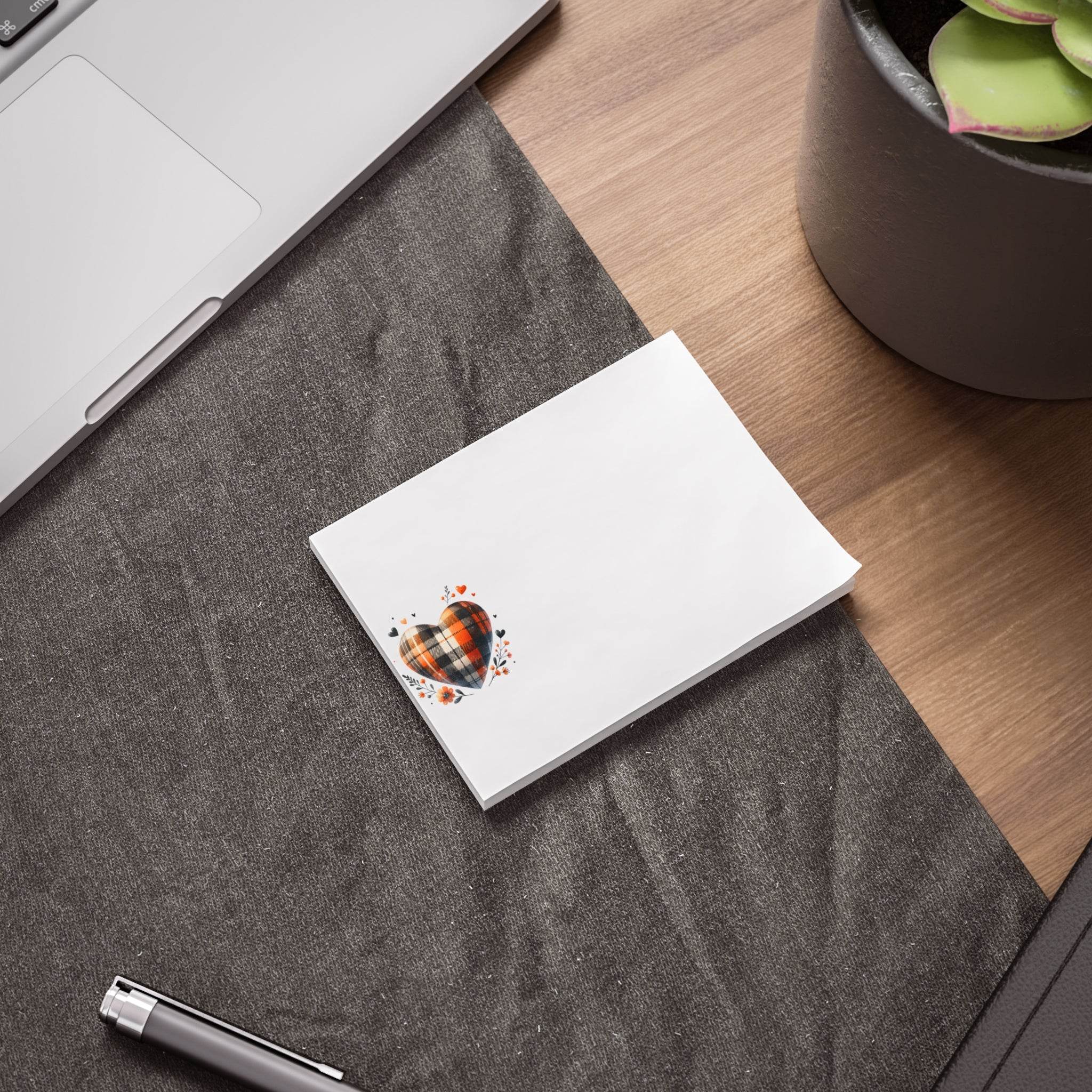 Printify eco-friendly note pads with heart design on white paper placed on desk near laptop and plant