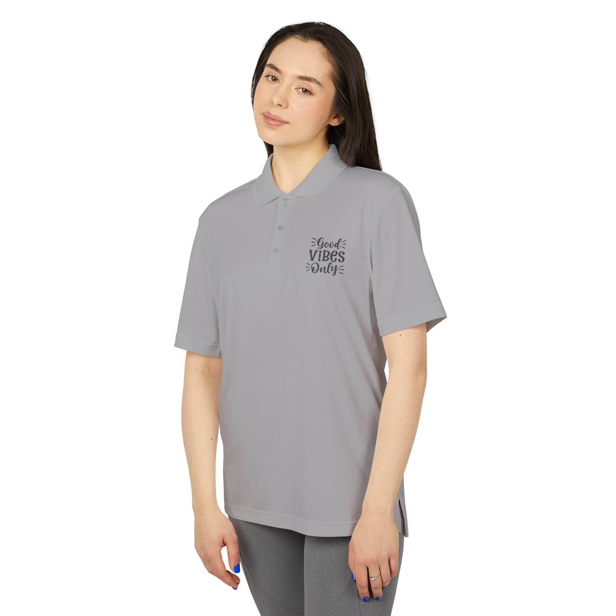Printify gray eco-friendly polo shirt with Good Vibes Only text worn by woman