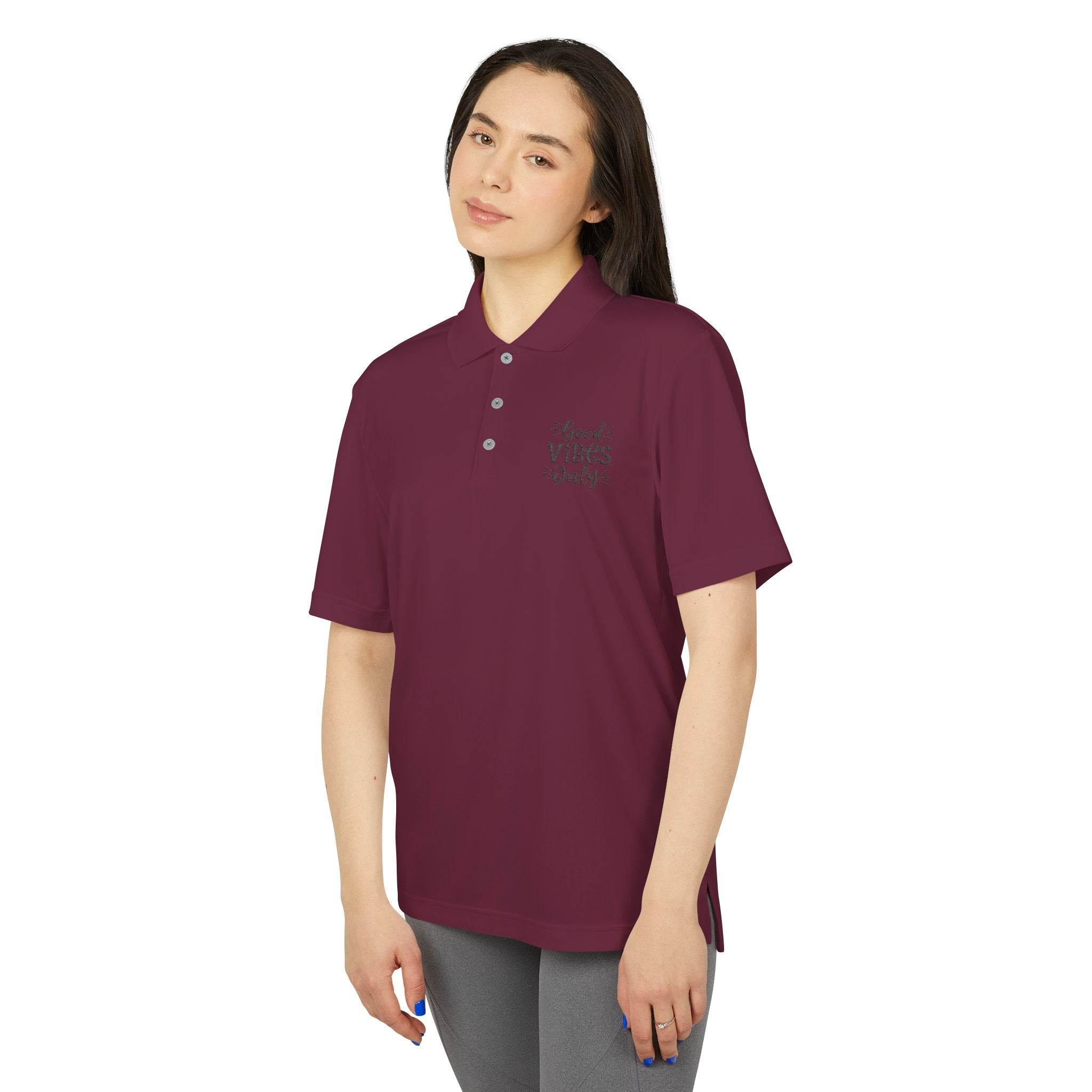 Woman wearing a maroon eco-friendly polo shirt with short sleeves and button collar