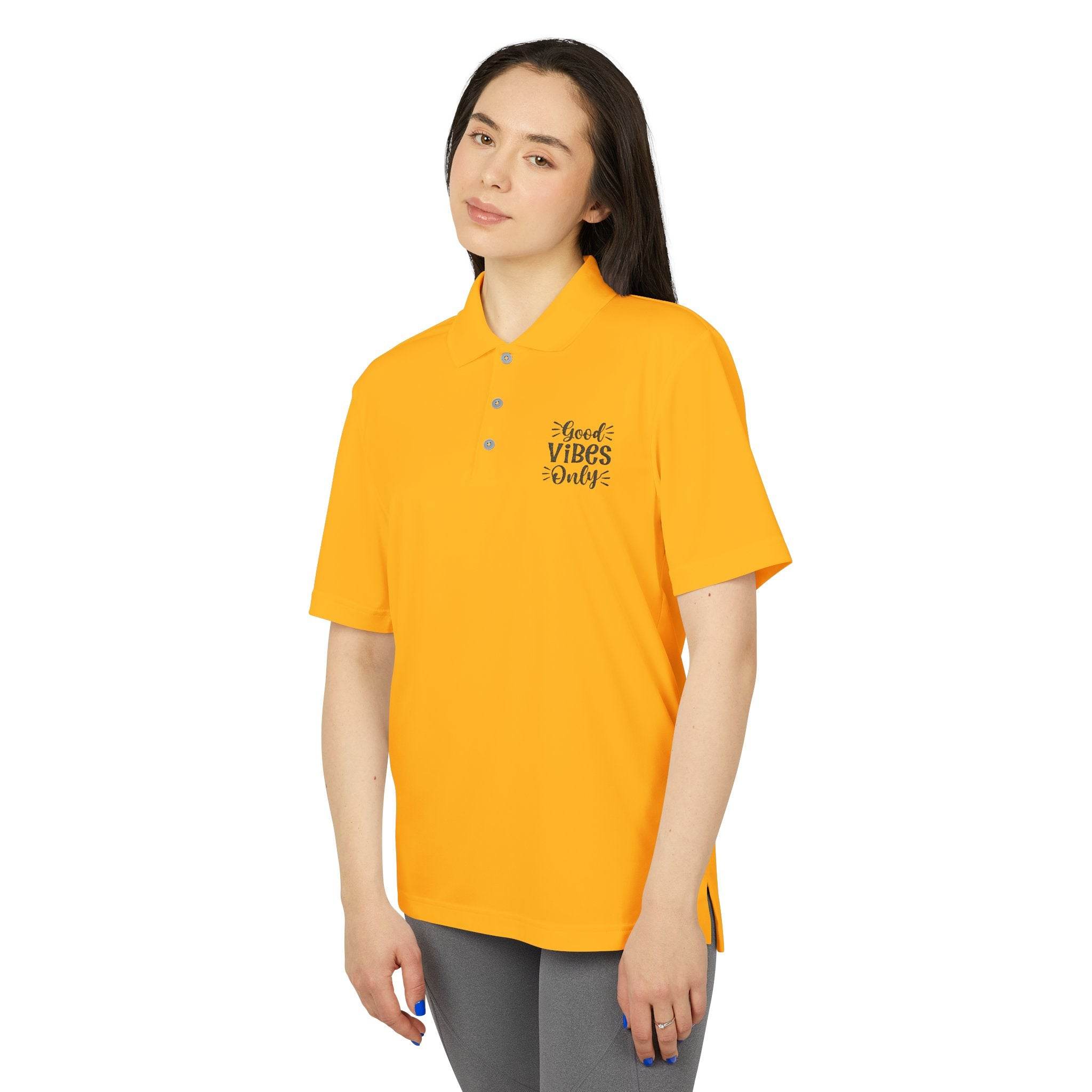 Printify eco-friendly polo shirt in bright yellow with Good Vibes Only text worn by woman