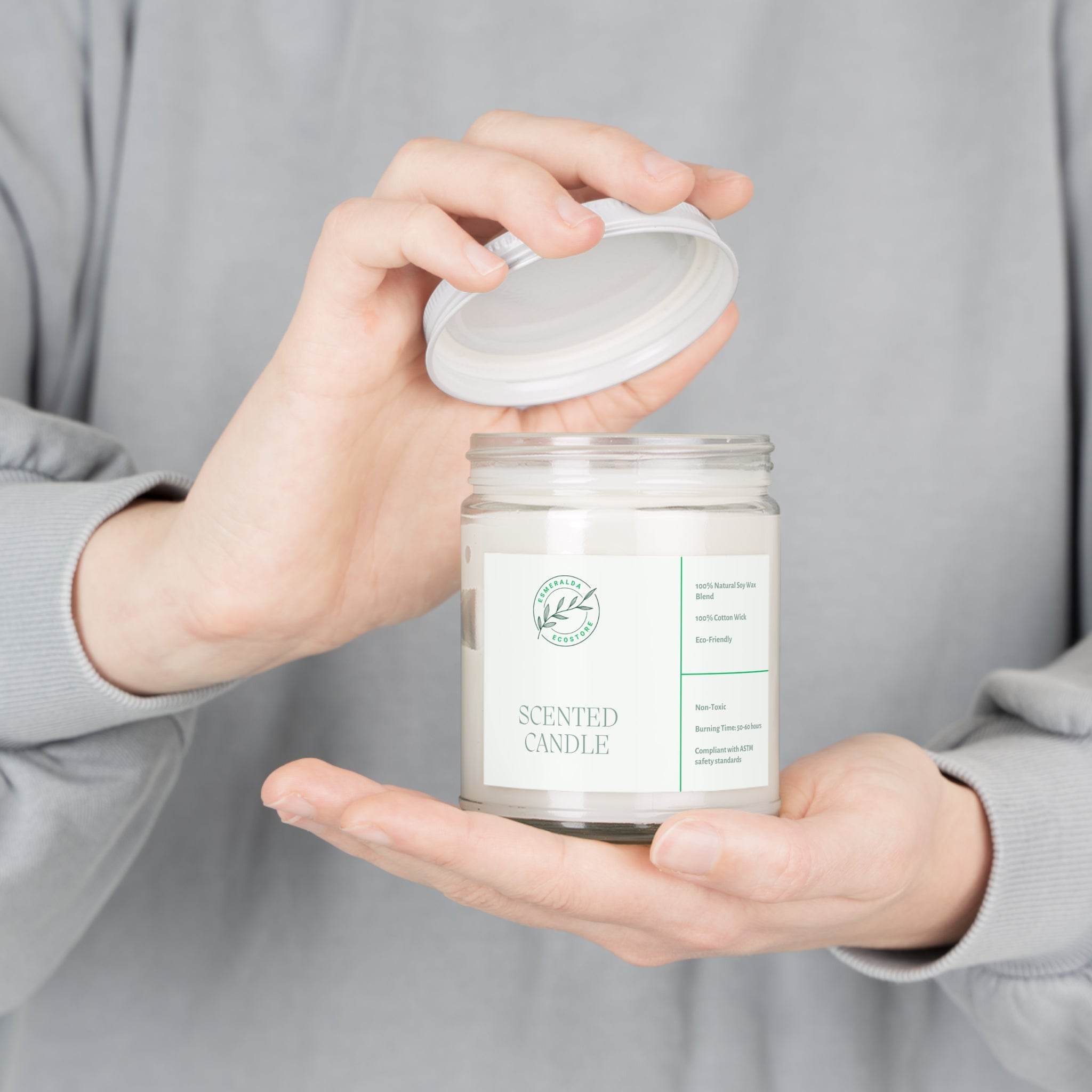 Printify eco-friendly scented candles in a clear glass jar with white lid held by person