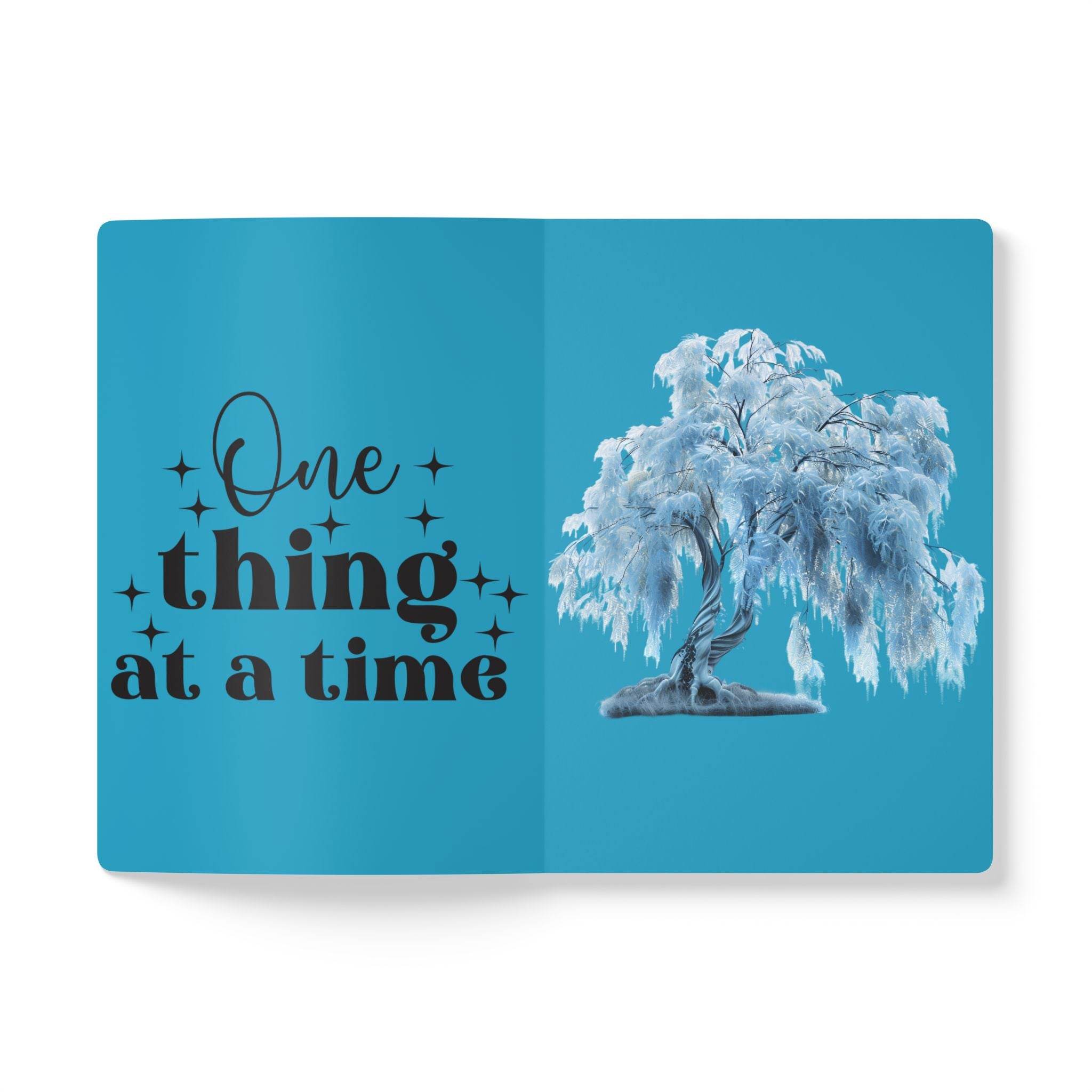 Printify eco-friendly softcover journal with blue cover featuring a tree and One thing at a time quote