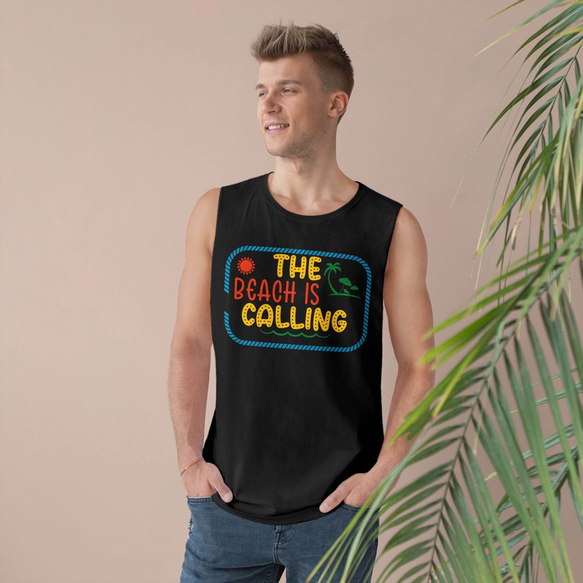 Printify black eco-friendly tank top with colorful The Beach Is Calling design worn by male model