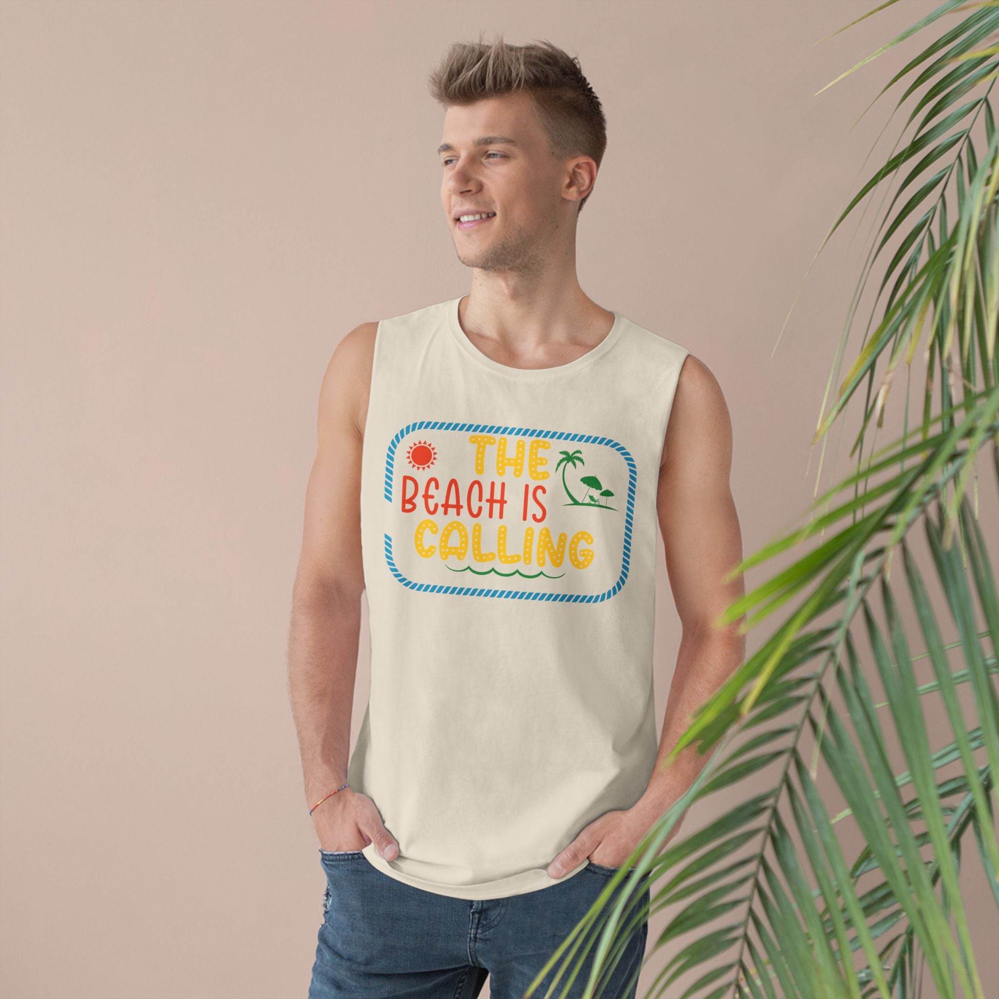 Man wearing a Printify eco-friendly tank top with beach-themed graphic and text The Beach Is Calling