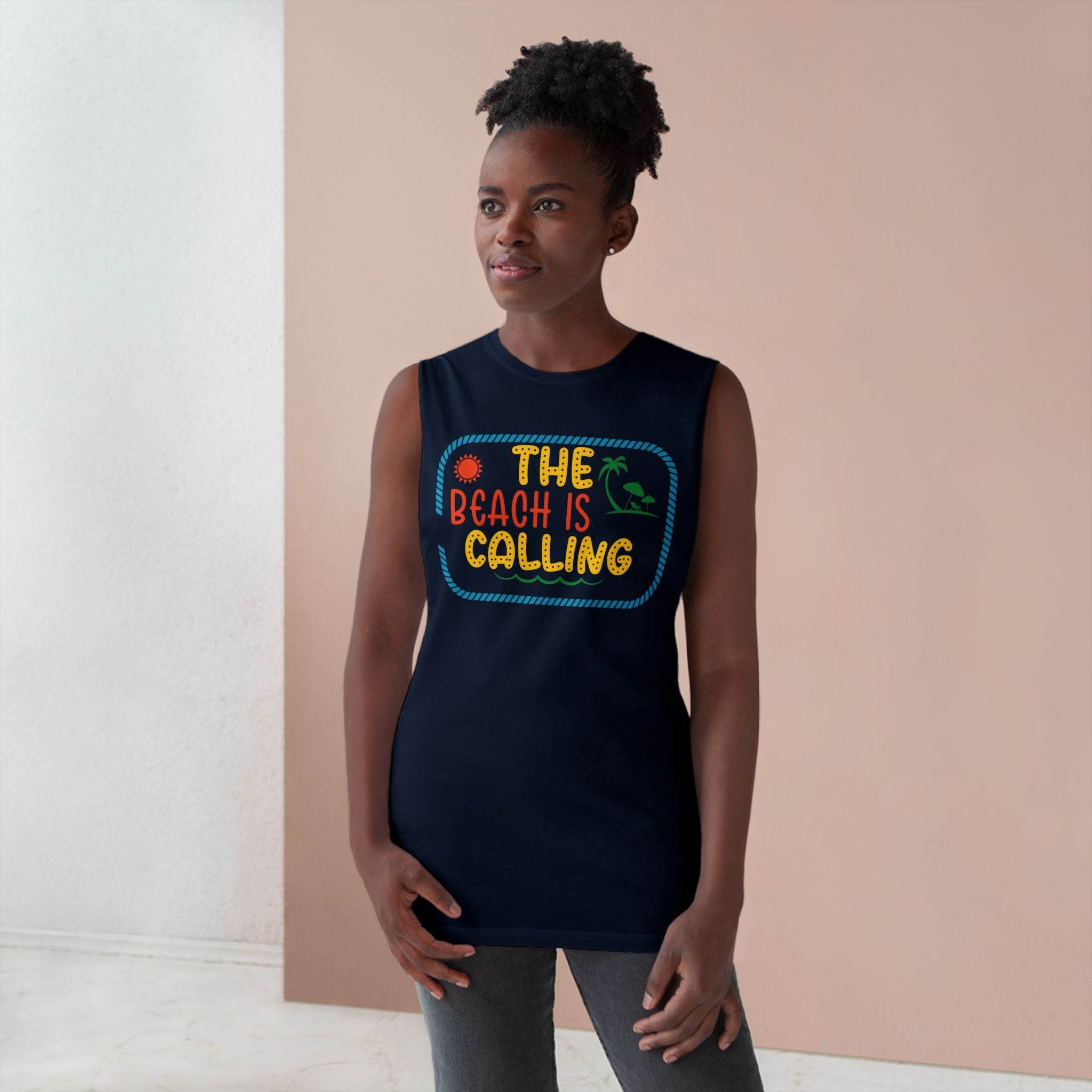 Woman wearing a navy blue eco-friendly tank top with colorful The Beach Is Calling graphic print