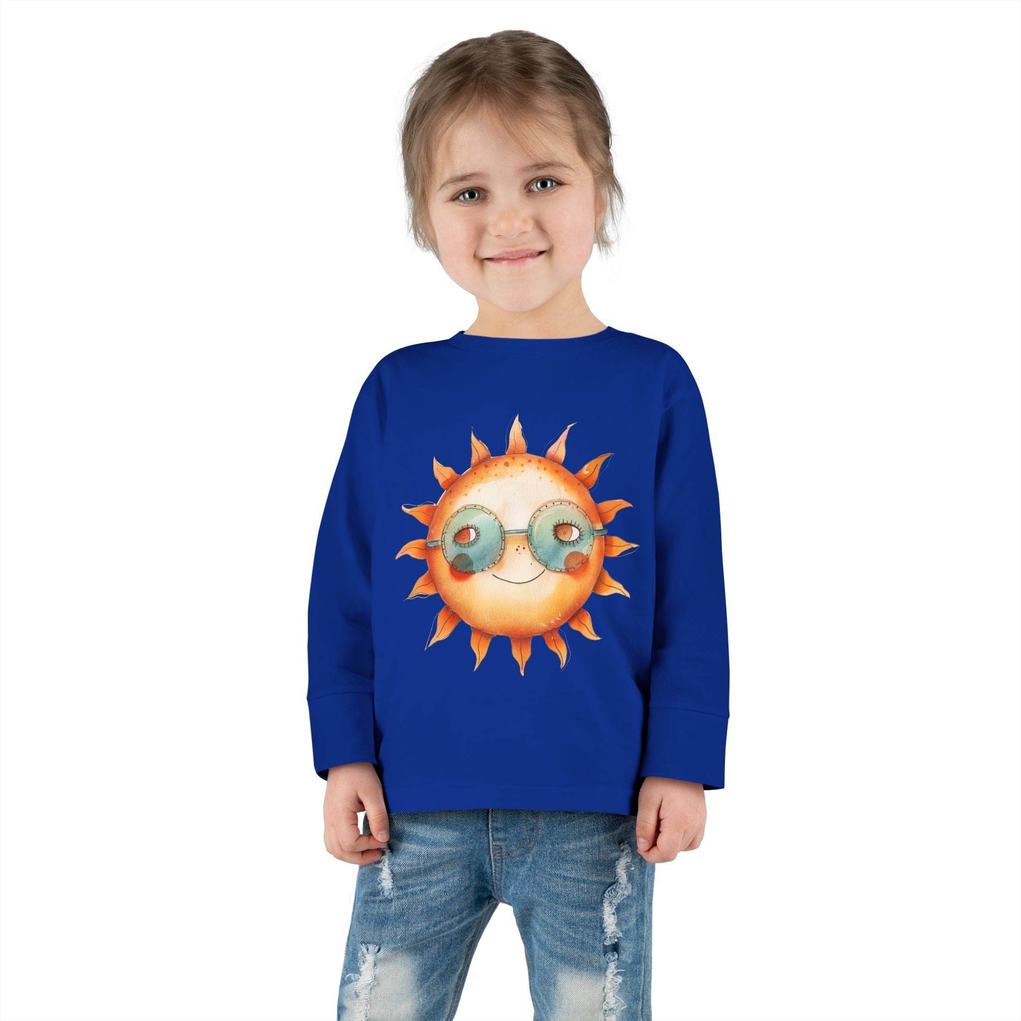 Toddler wearing blue eco-friendly toddler long sleeve shirt with sun graphic and sunglasses