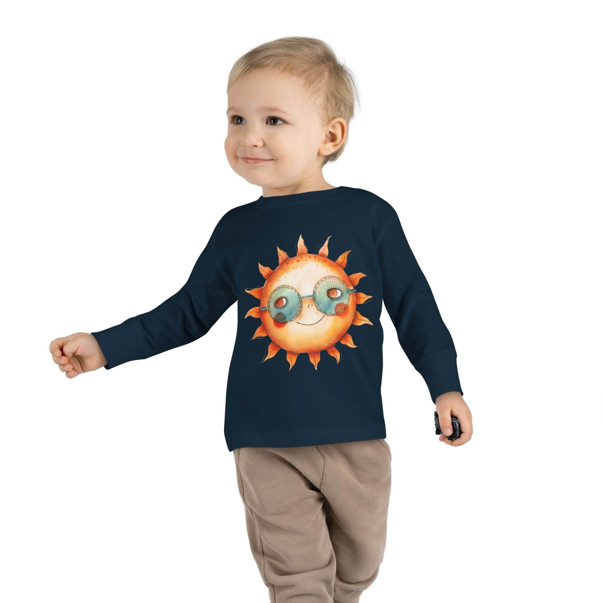 Toddler wearing navy eco-friendly toddler long sleeve shirt with sun graphic and sunglasses