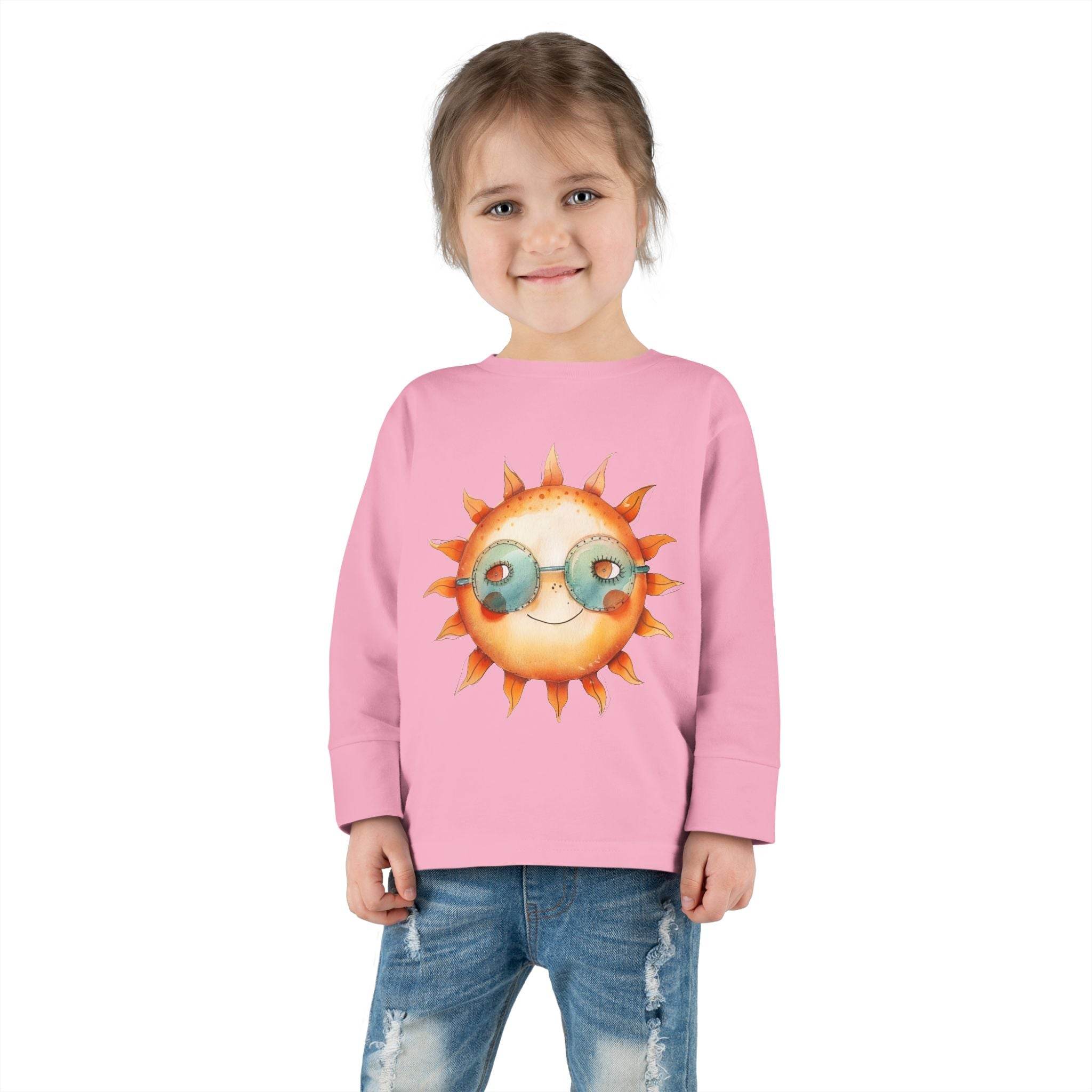 Child wearing a pink eco-friendly toddler long sleeve shirt with a sun graphic and glasses
