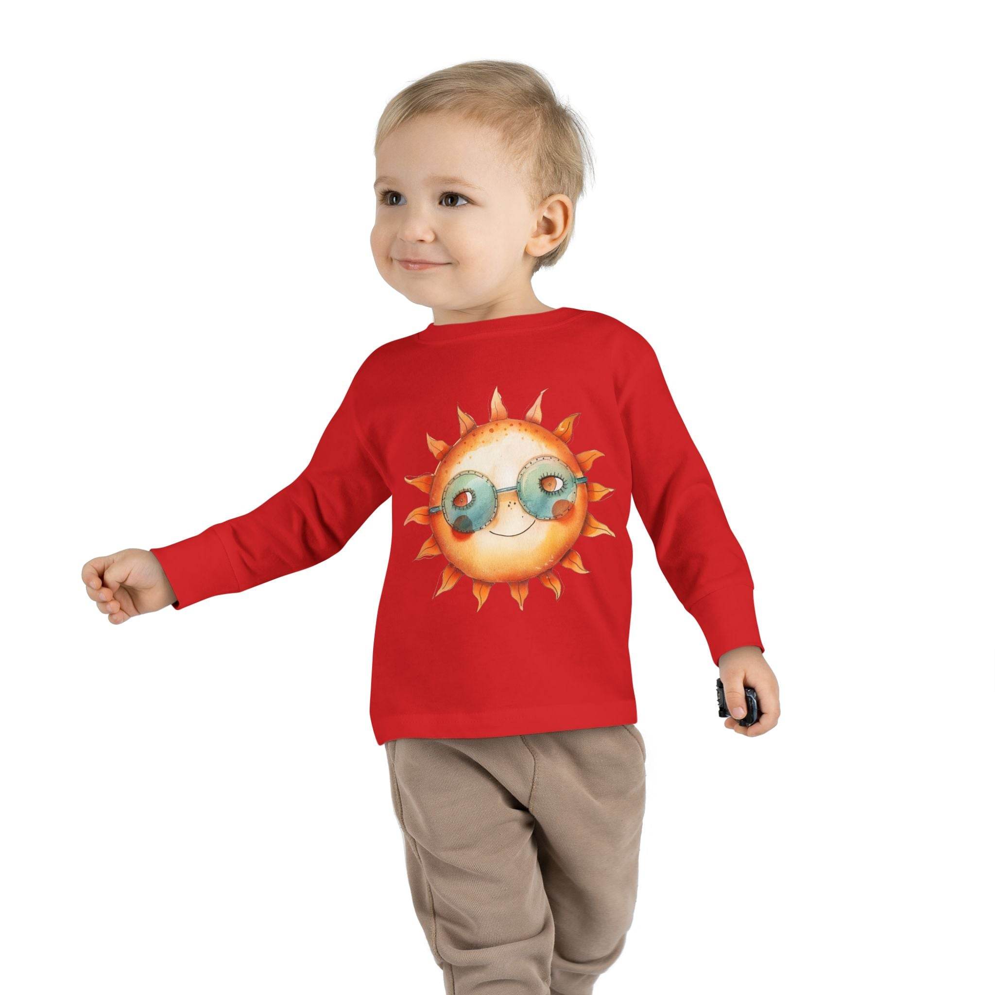 Printify eco-friendly toddler long sleeve shirt in red with a sun wearing glasses graphic