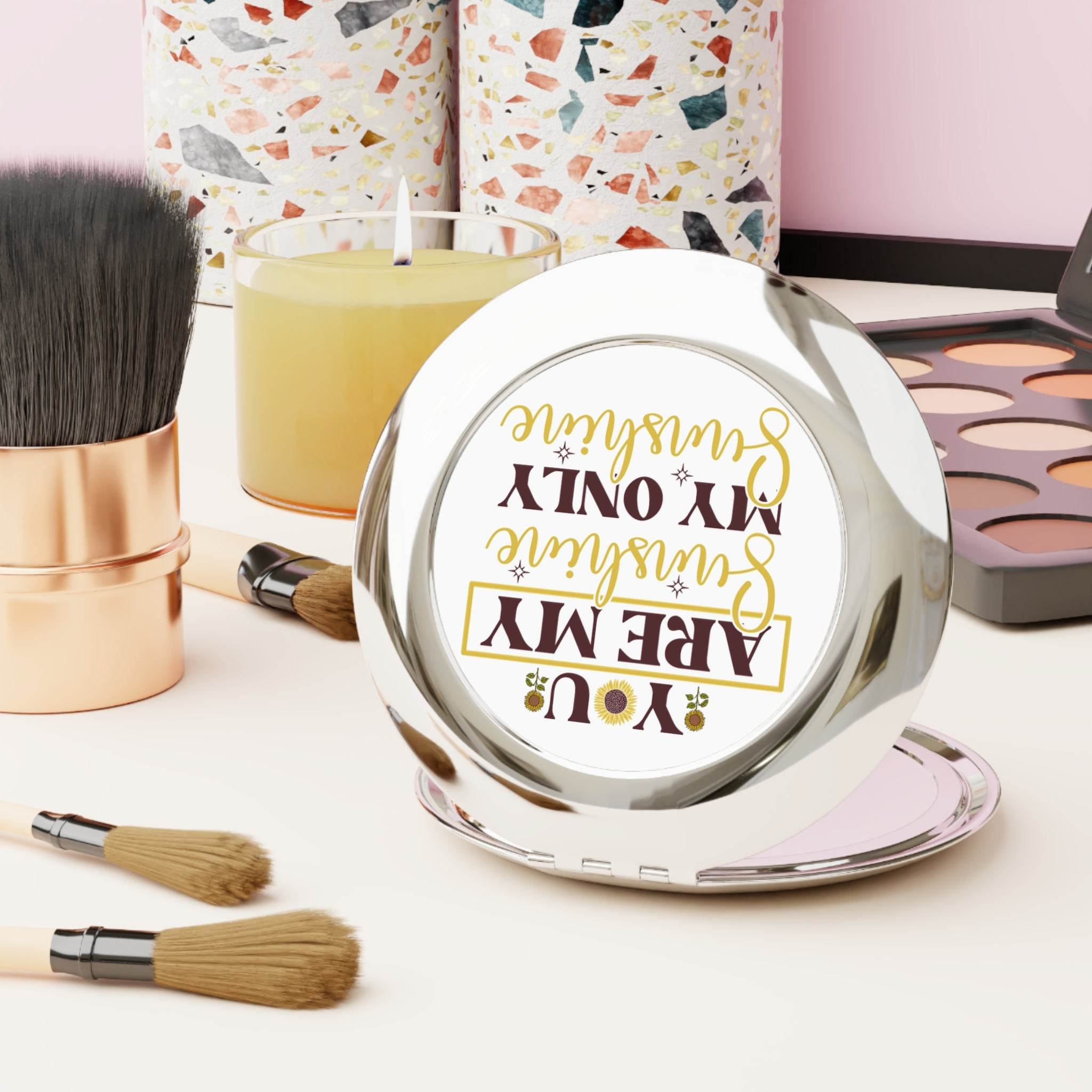 Printify eco-friendly travel mirror with inspirational text, surrounded by makeup brushes and cosmetics