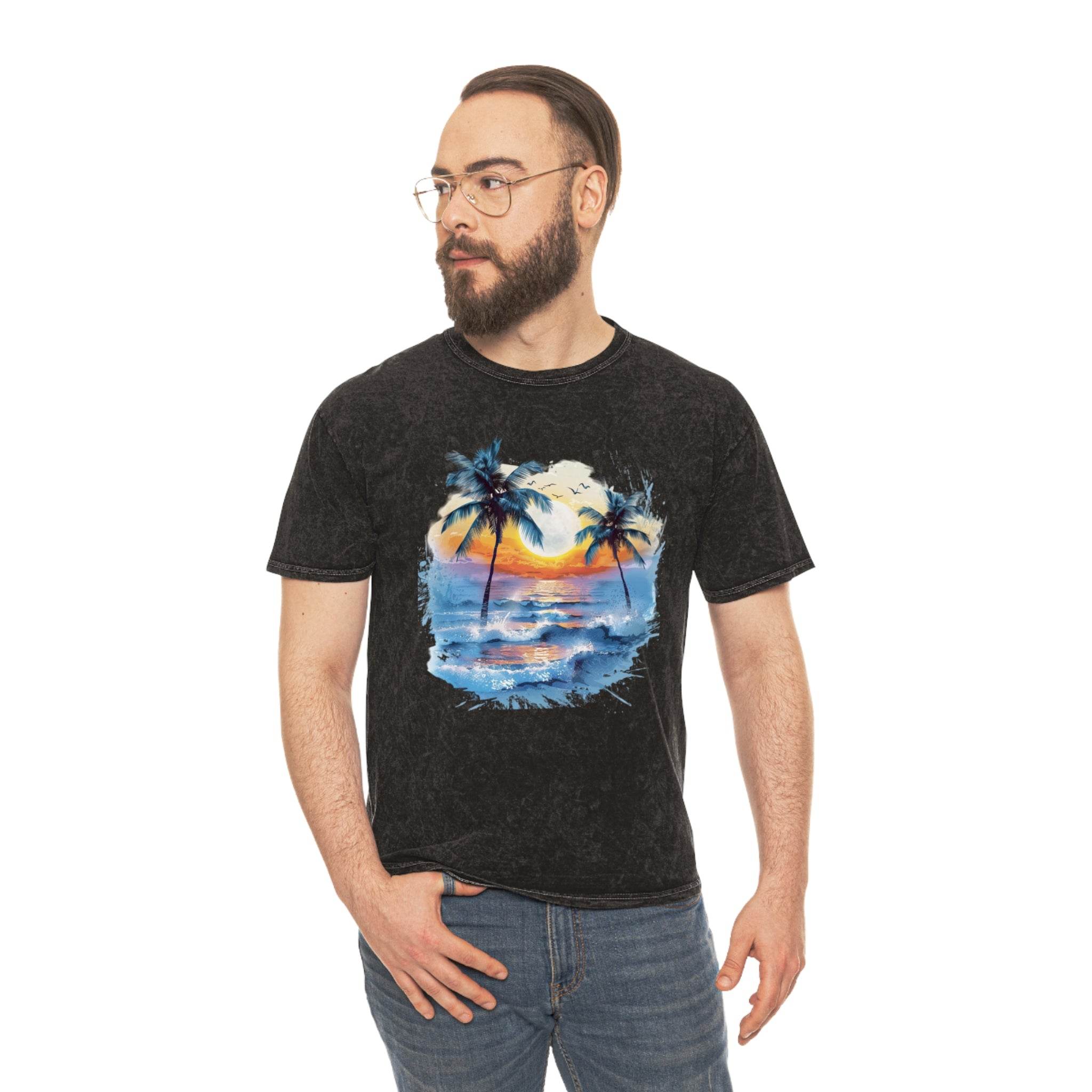 Printify eco-friendly tropical t-shirt with sunset and palm tree design worn by man with glasses