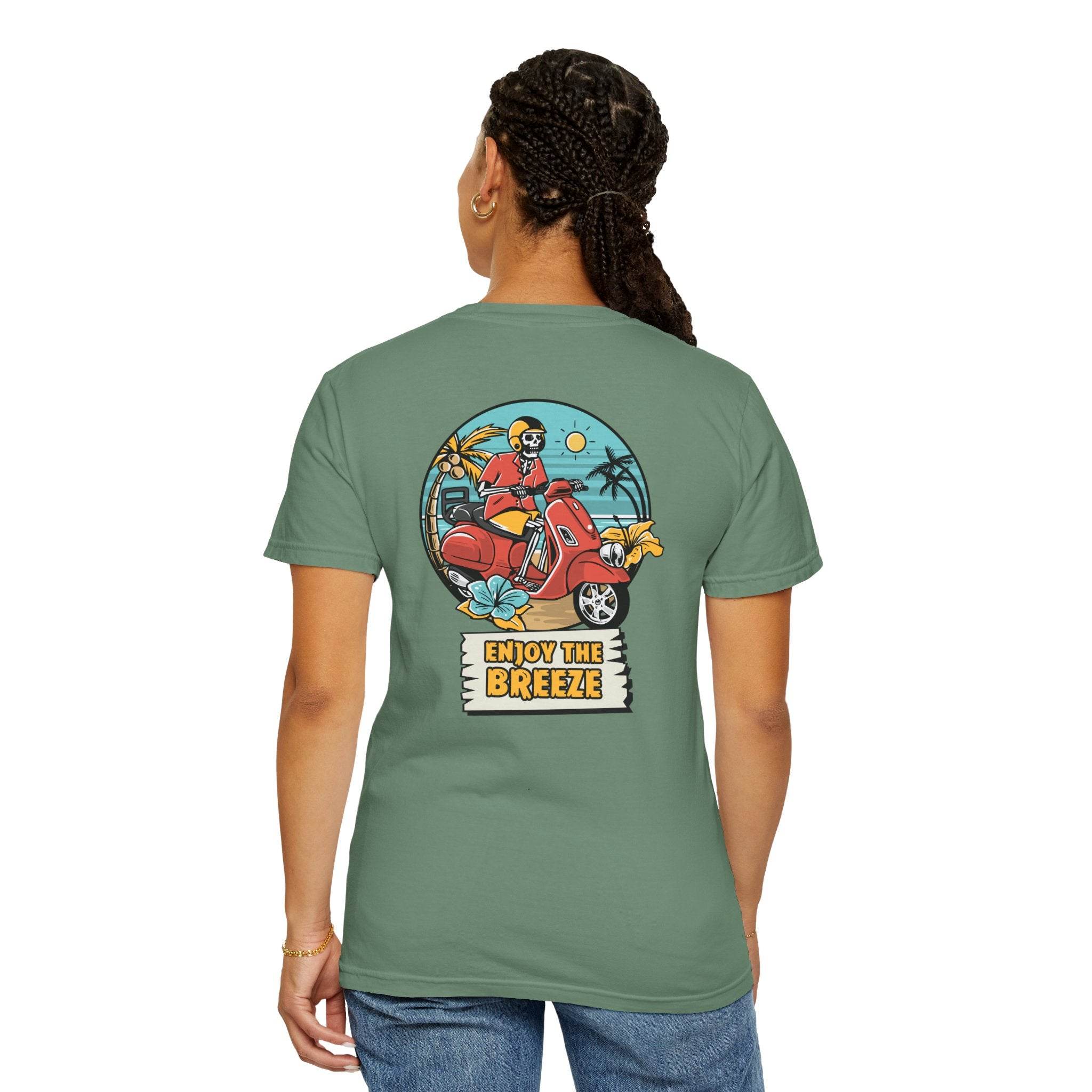 Printify eco-friendly unisex t-shirt in green with colorful back graphic of person on scooter and Enjoy the Breeze text