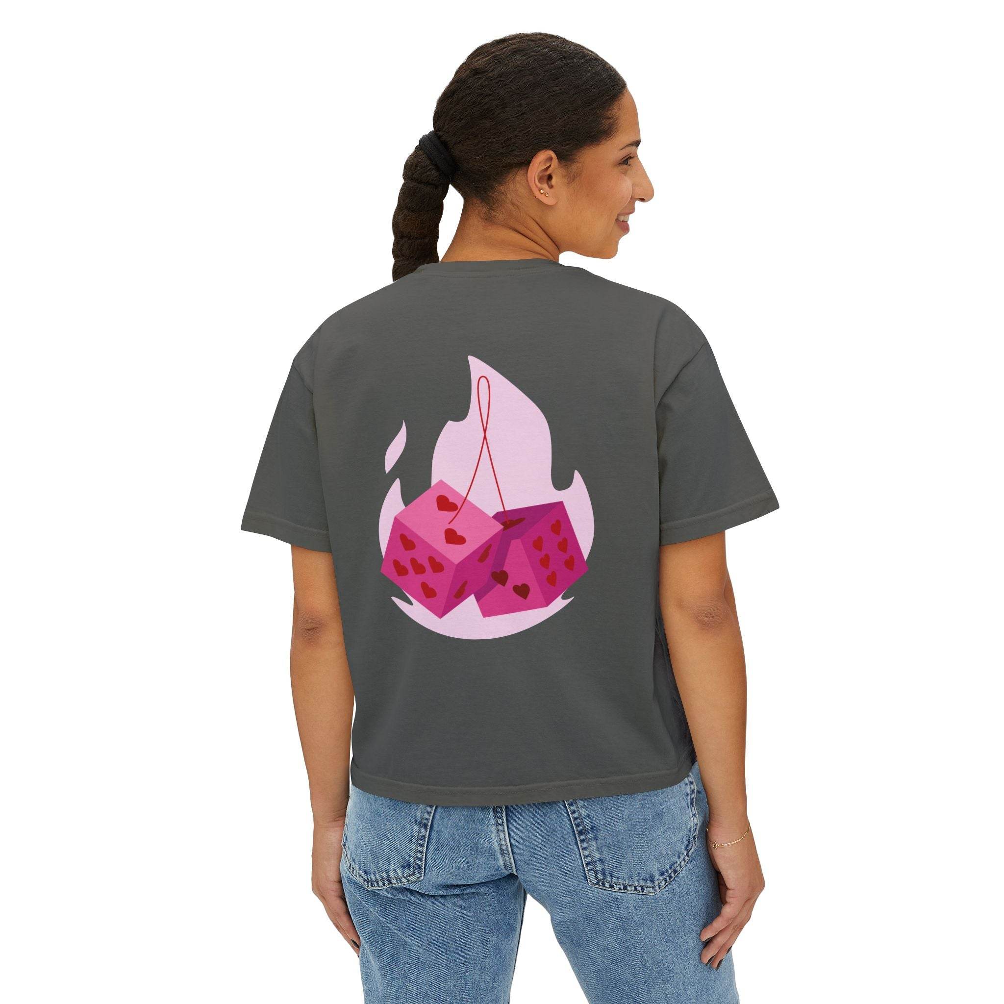 Printify eco-friendly women boxy tee in dark gray with pink dice graphic on the back worn by a woman