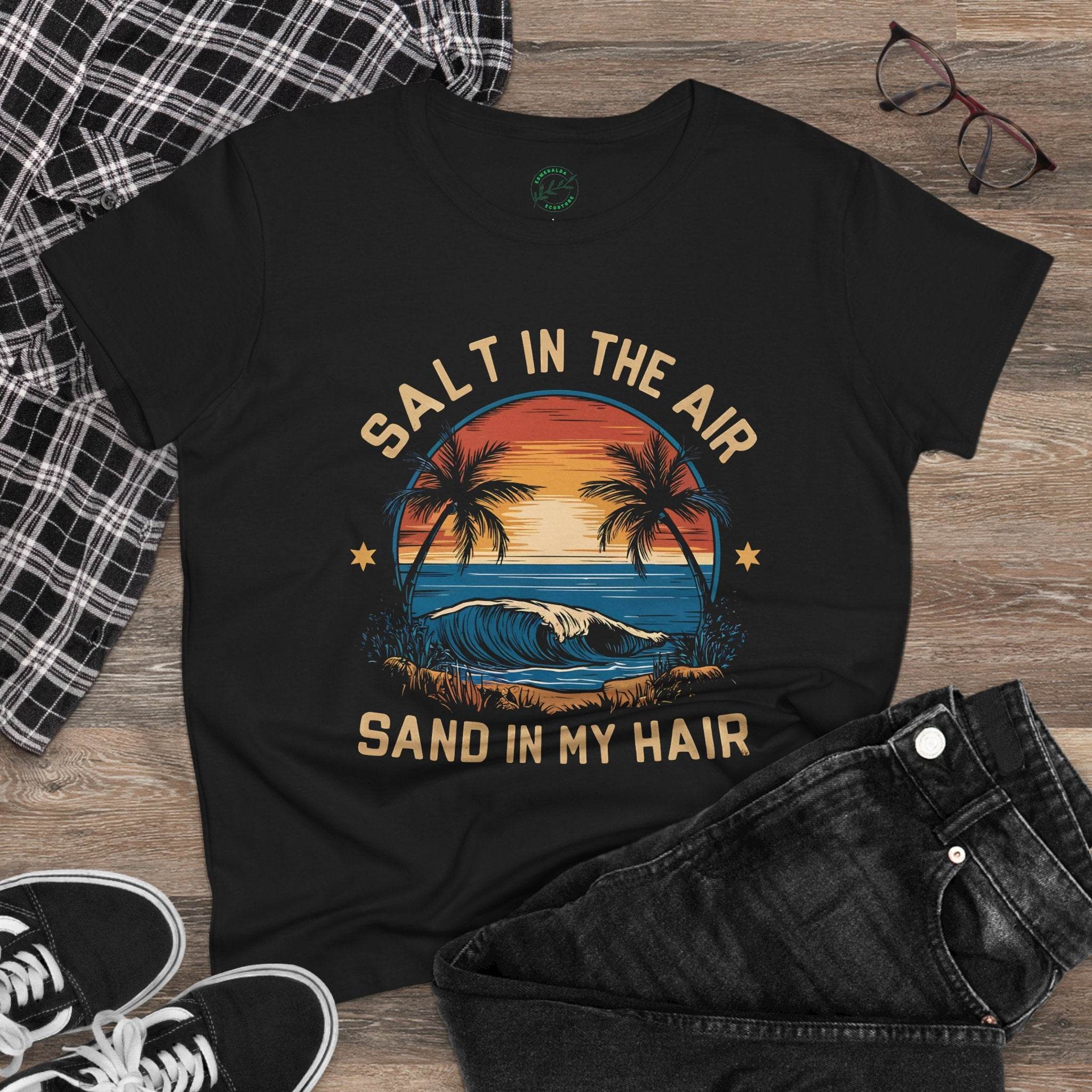 Printify black eco-friendly women's cotton tee with sunset beach design and Salt in the Air text