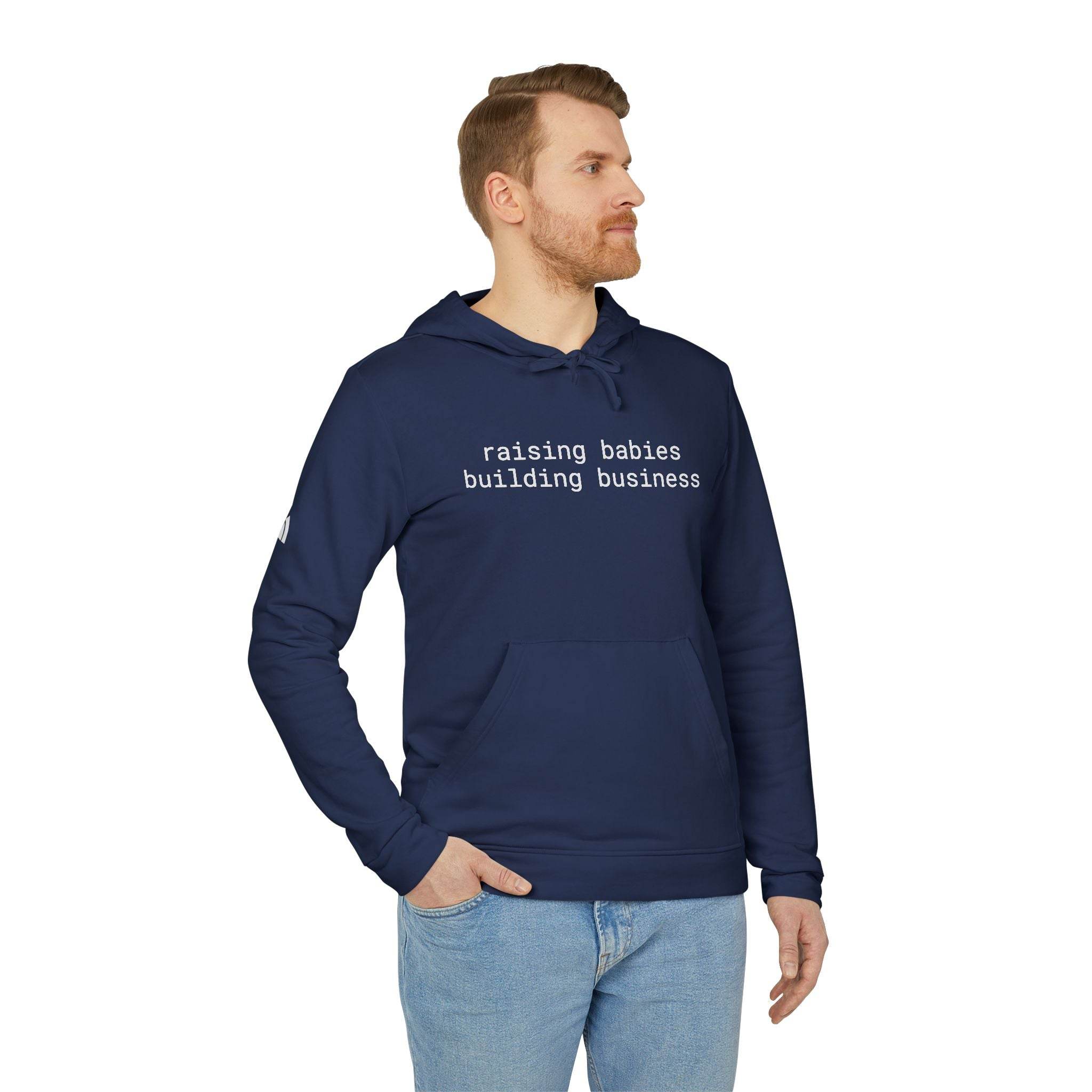 Printify navy blue eco-friendly unisex fleece hoodie with white text raising babies building business on model