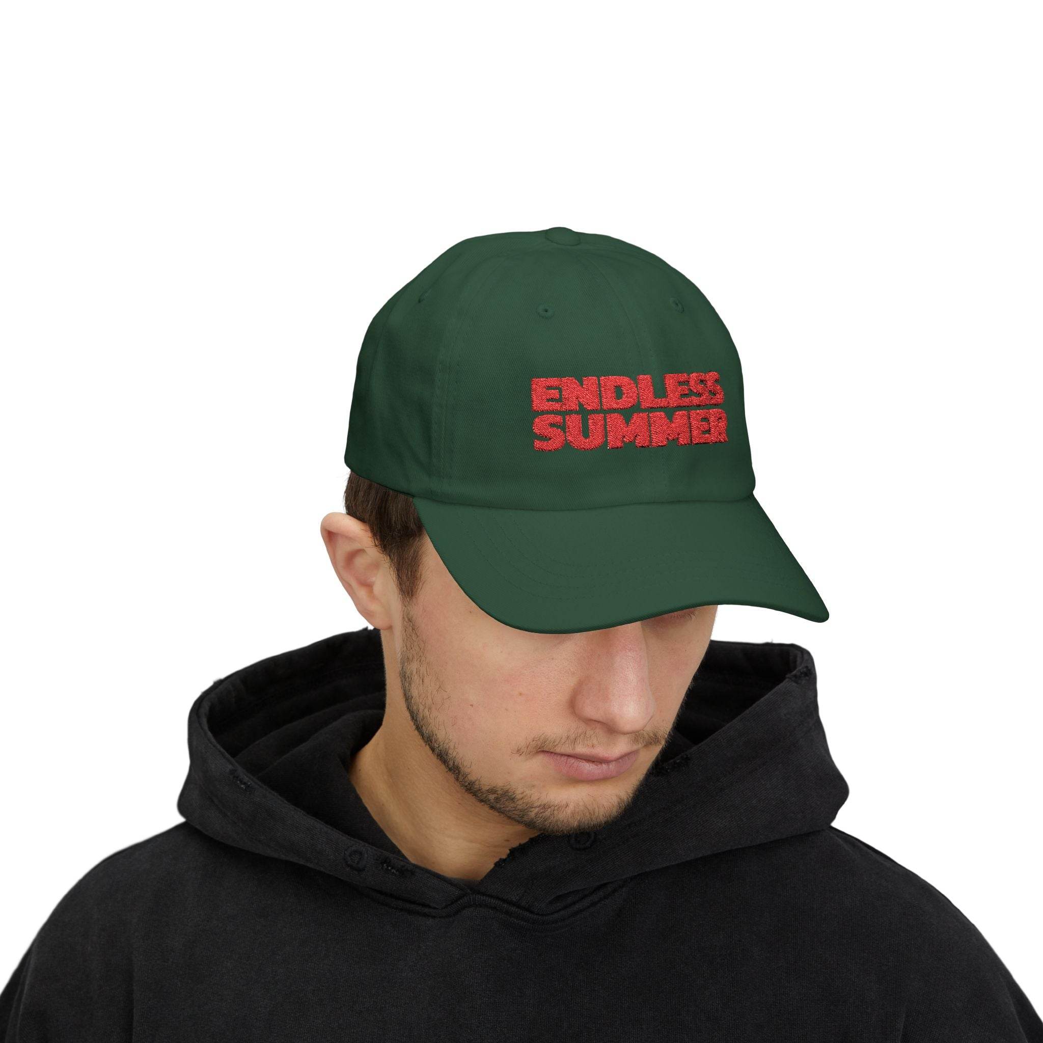 Printify eco-friendly dad cap in dark green with red Endless Summer text worn by man in black hoodie
