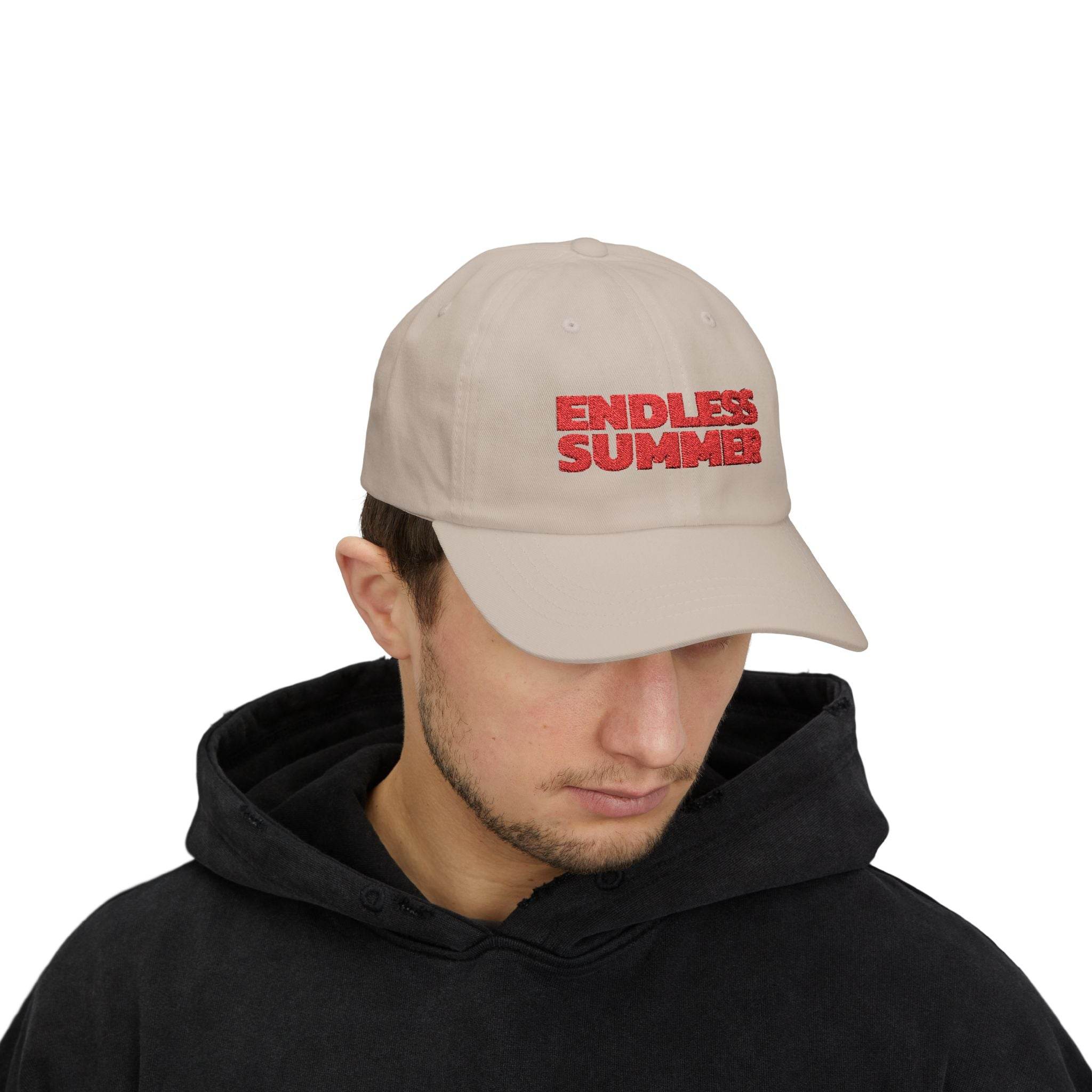 Beige eco-friendly dad cap with red Endless Summer text embroidered on front worn by man