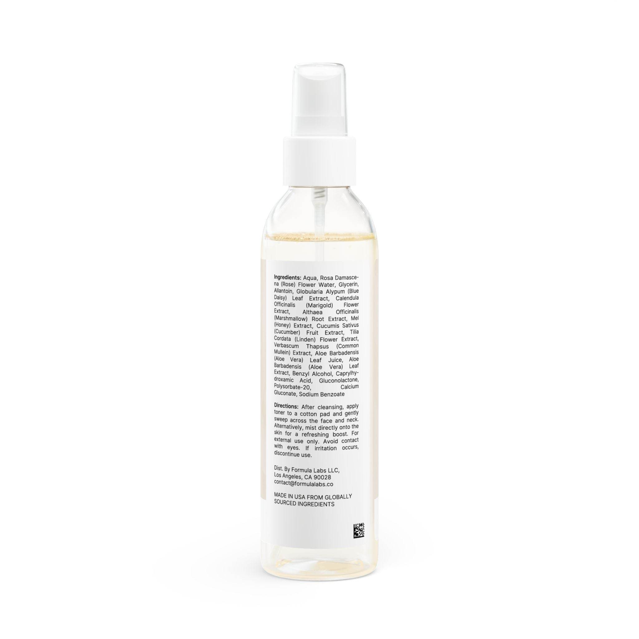 Clear spray bottle of natural face toner for sensitive skin with white label and pump dispenser