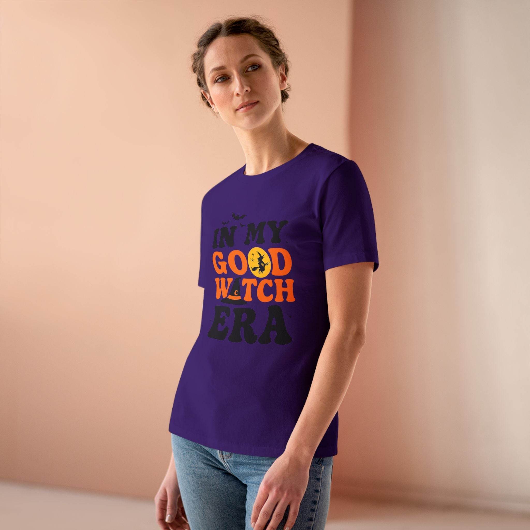 Printify purple fitted tee with In My Good Witch Era orange and black design on model eco friendly halloween t shirt women
