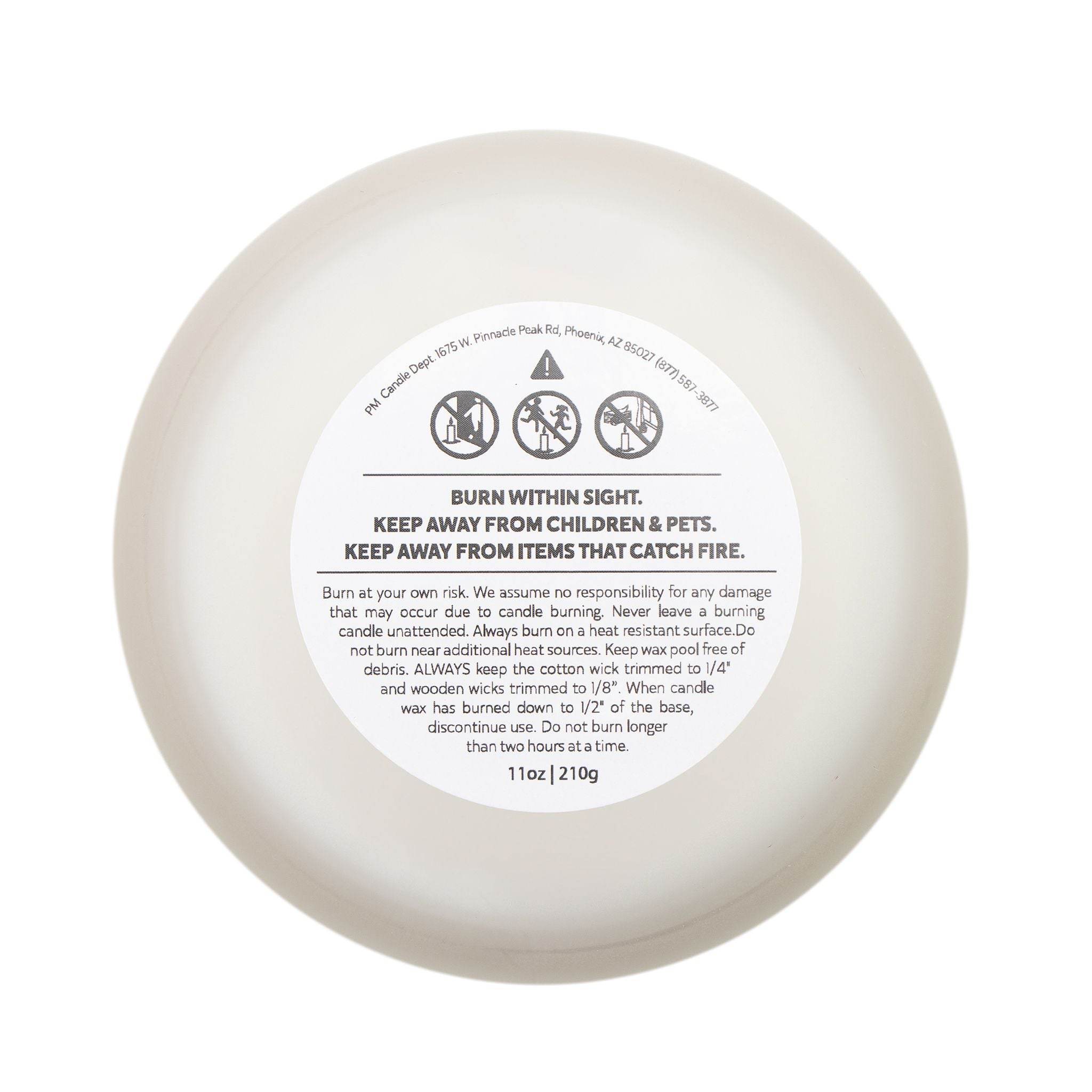 Bottom view of frosted glass eco candle showing safety and usage instructions label