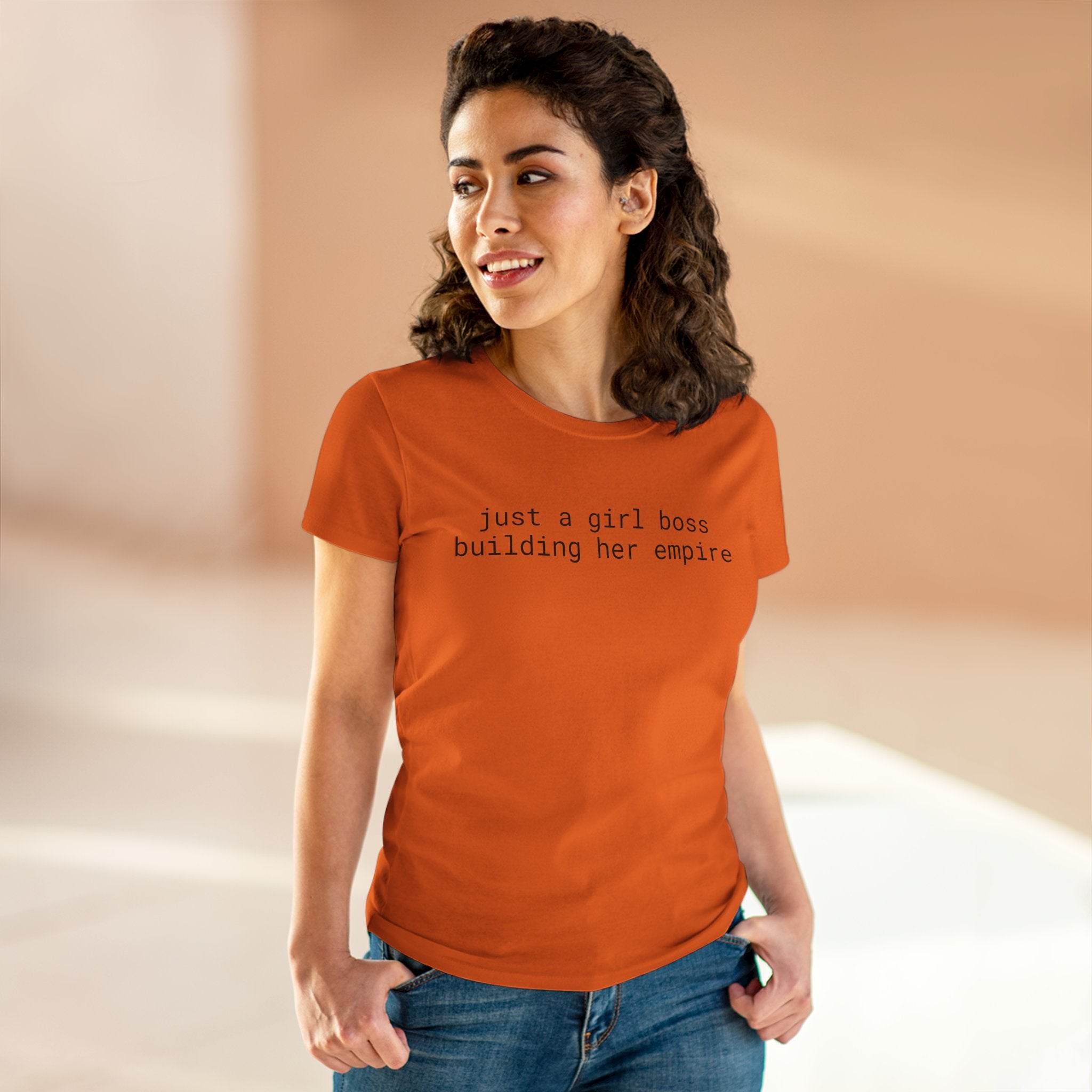 Printify eco-friendly girl boss shirt on smiling woman wearing orange tee reading just a girl boss building her empire