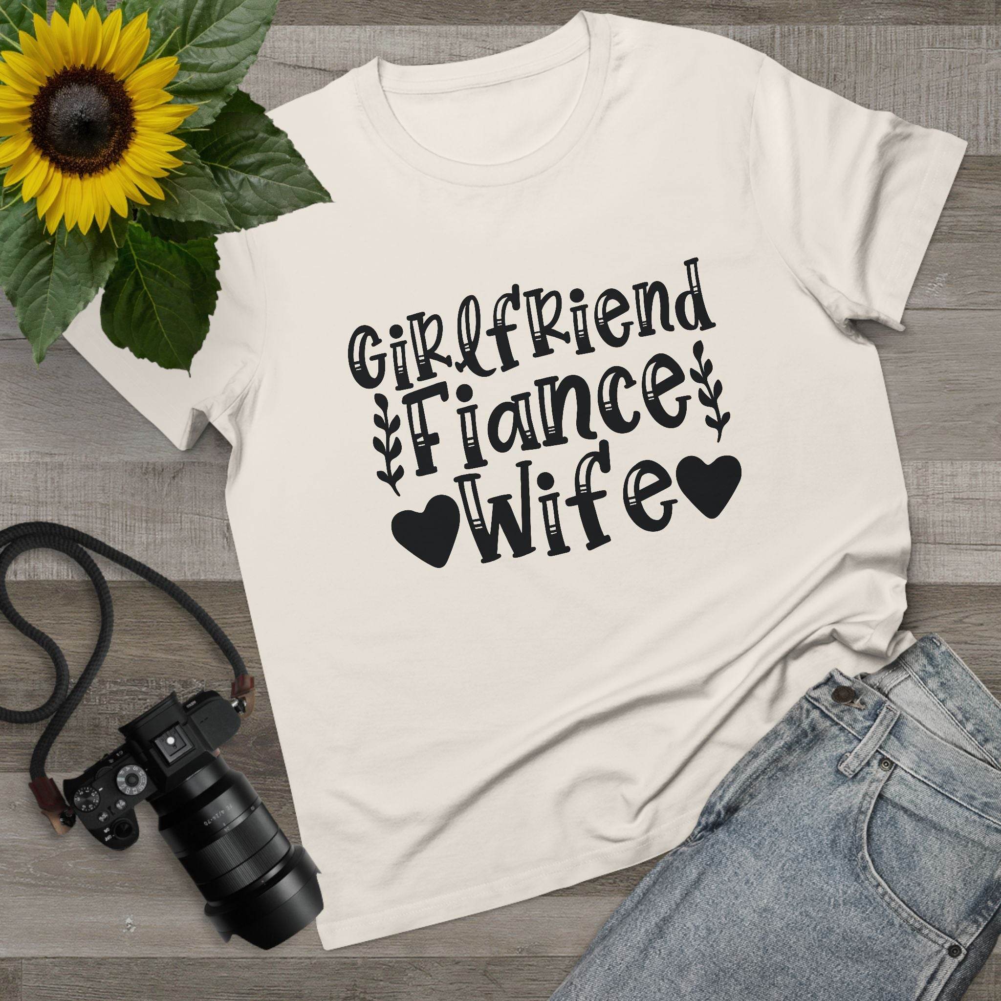 Cream eco-friendly women's relationship tee with black Girlfriend Fiance Wife design and heart leaf accents, flat lay
