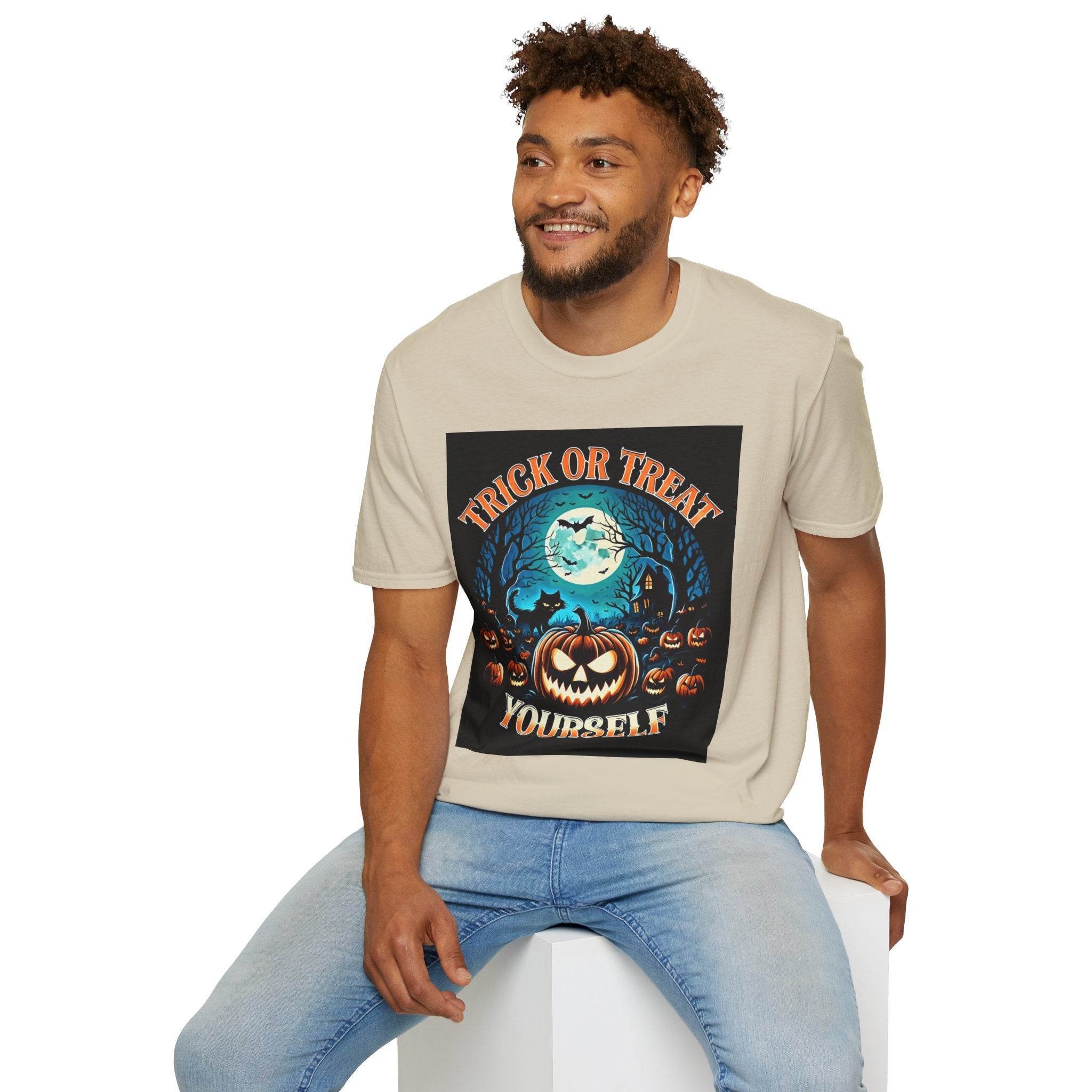 Printify eco-friendly Halloween t-shirt beige crewneck with pumpkin moon graphic worn by smiling seated man