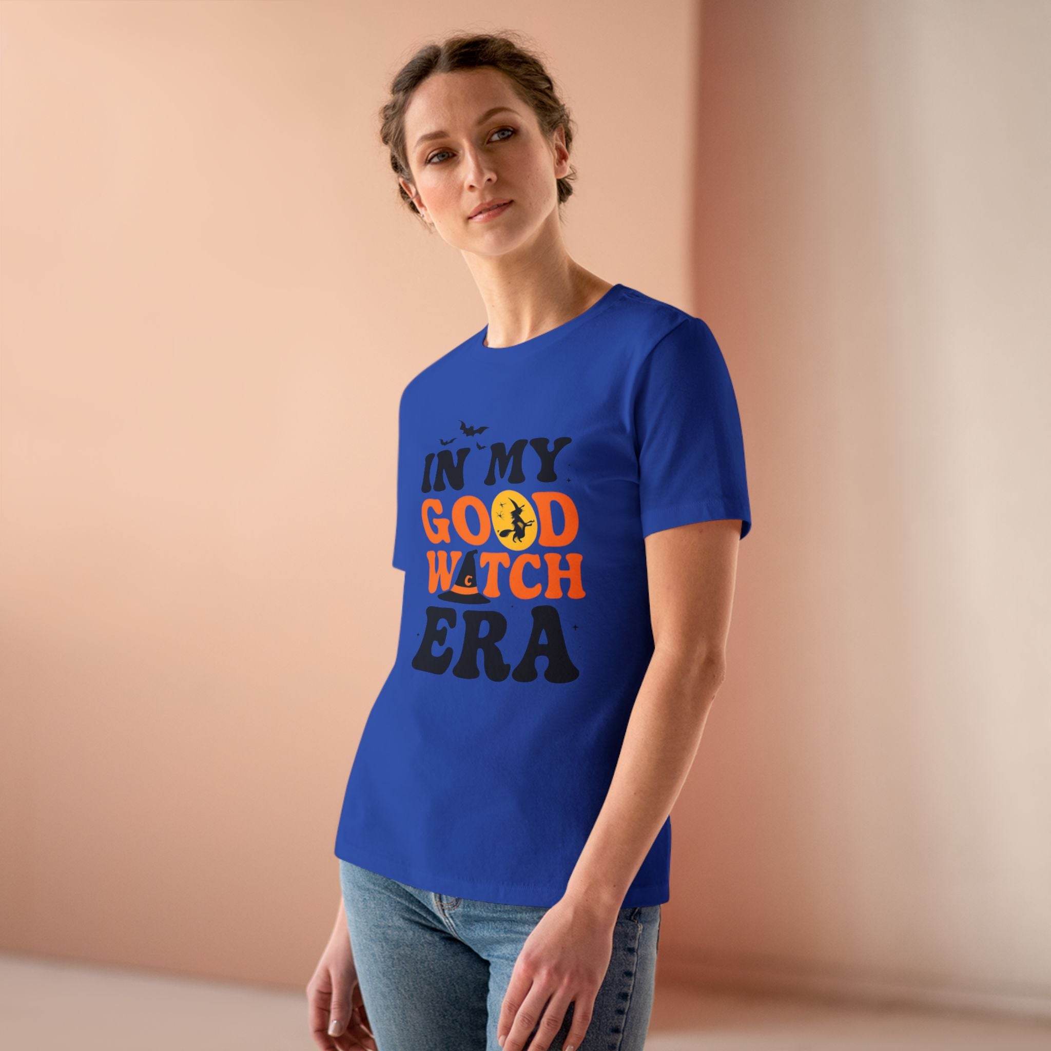 Woman wearing blue eco friendly halloween t shirt women printed with In My Good Witch Era text and moon graphic