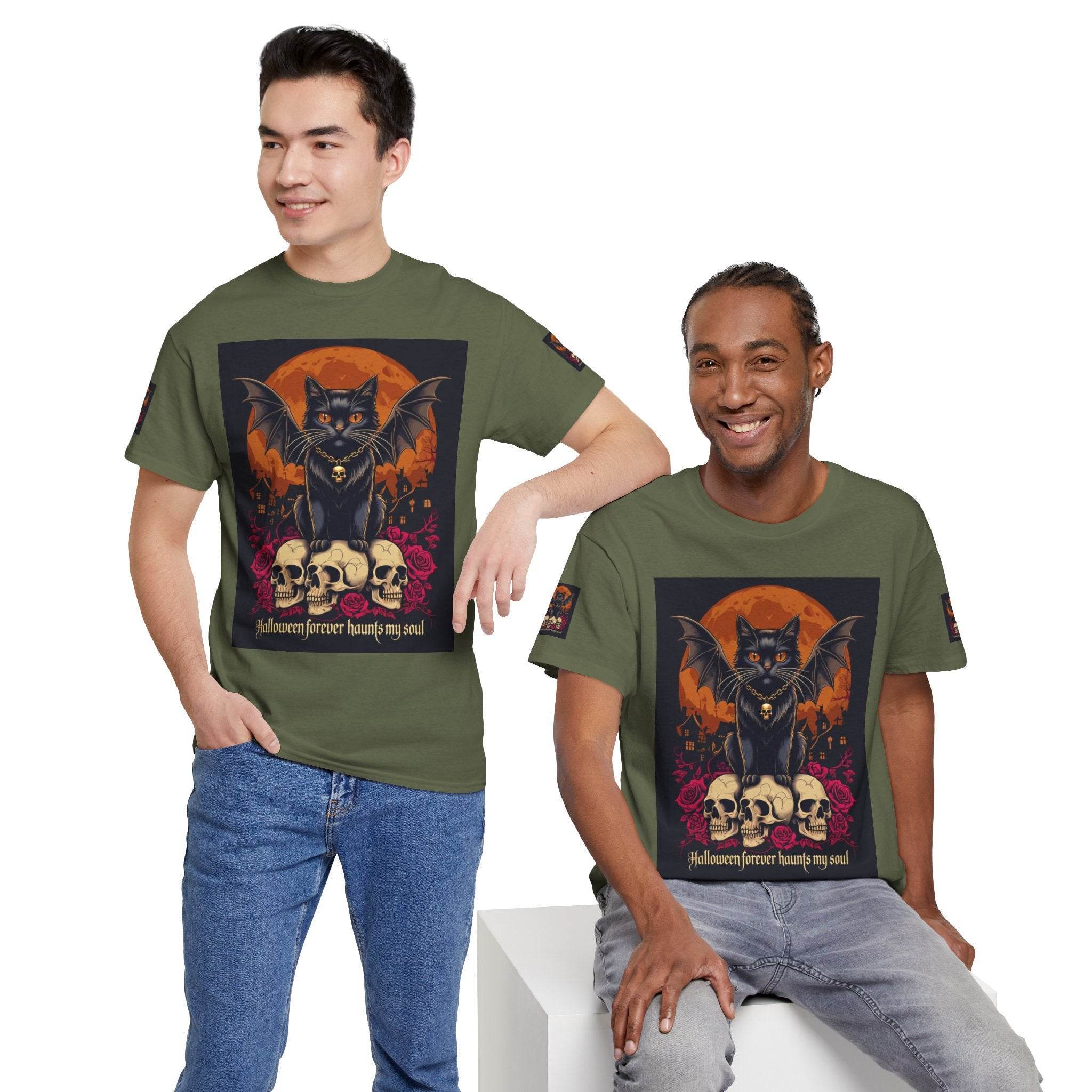 Two men modeling Printify eco-friendly Halloween cat shirt olive green tee with bat winged black cat over skulls and orange moon