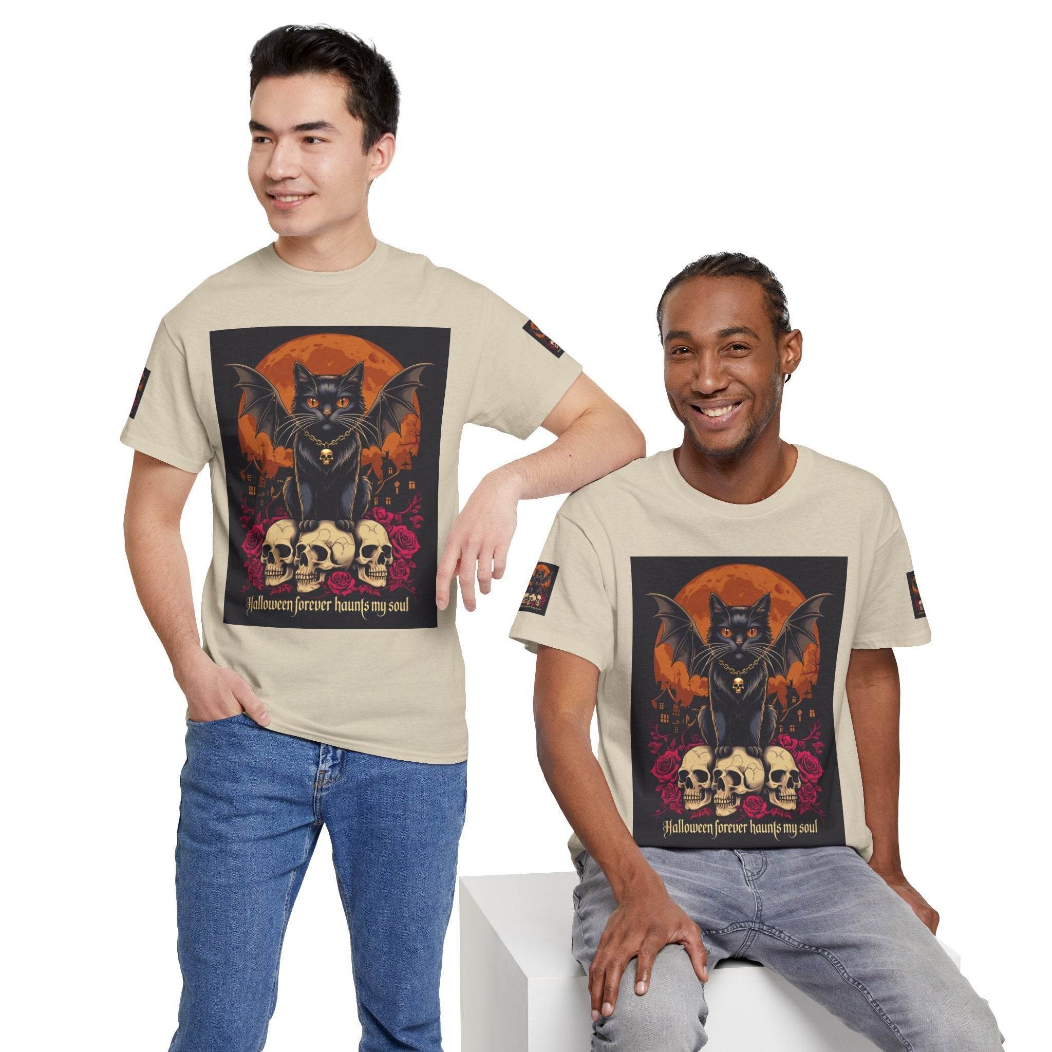Printify eco-friendly Halloween cat shirt beige tee featuring black bat winged cat on skulls by orange moon