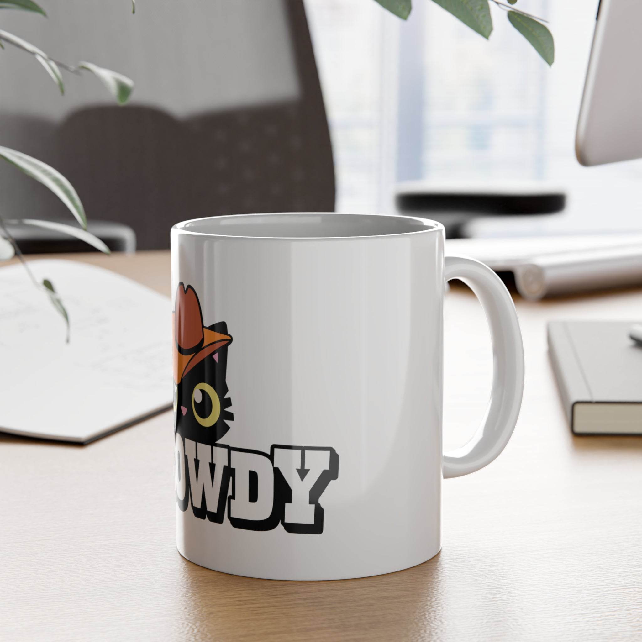 Printify eco-friendly ceramic mug with black cat and howdy design on a wooden desk