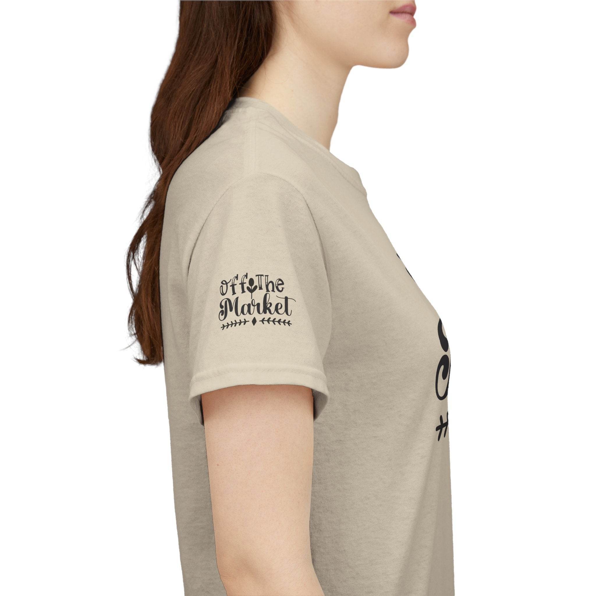 Side view of model wearing beige eco-friendly unisex t-shirt with Off the Market sleeve logo
