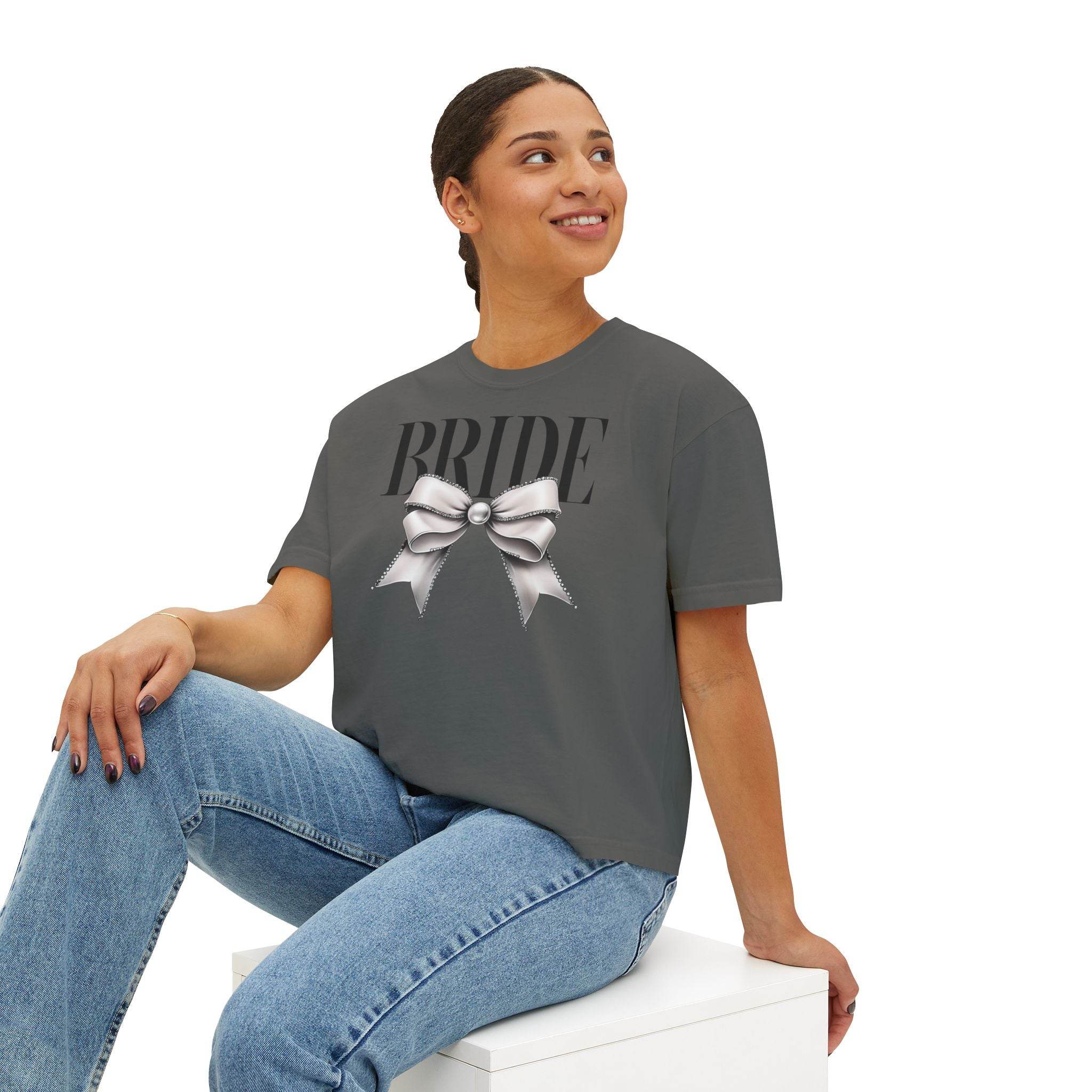 Printify eco-friendly bridal t-shirt charcoal gray with BRIDE text and silver bow worn by smiling model sitting