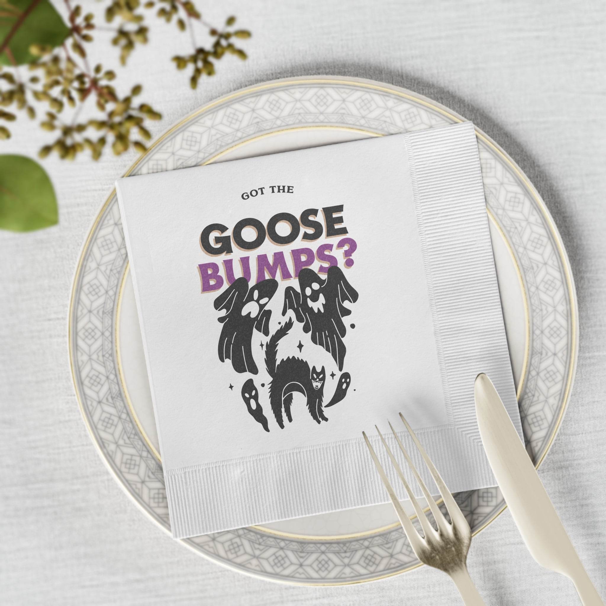 White napkin with spooky ghost and black cat design and purple GOOSE BUMPS text on plate eco-friendly Halloween napkins