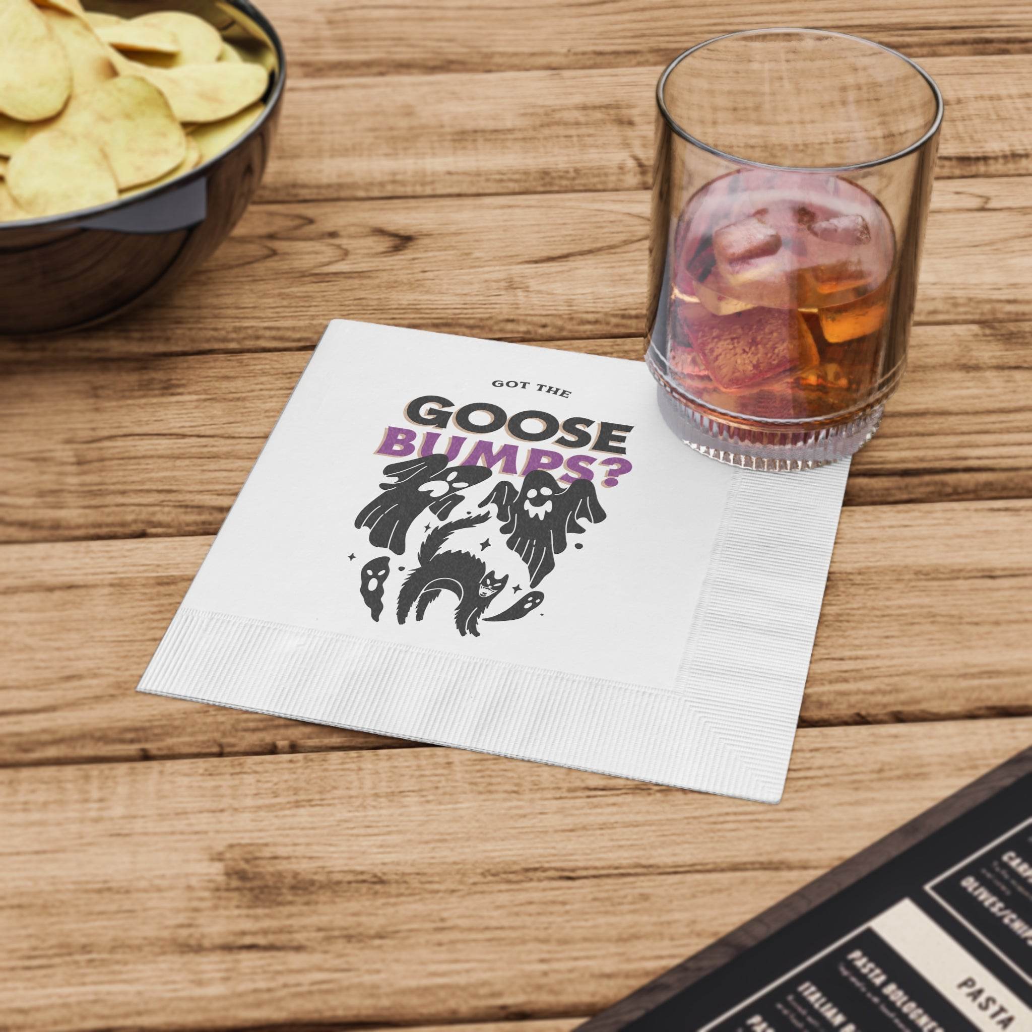 Printify eco-friendly Halloween napkins white square with Got the Goose Bumps ghost design under a glass on wood table