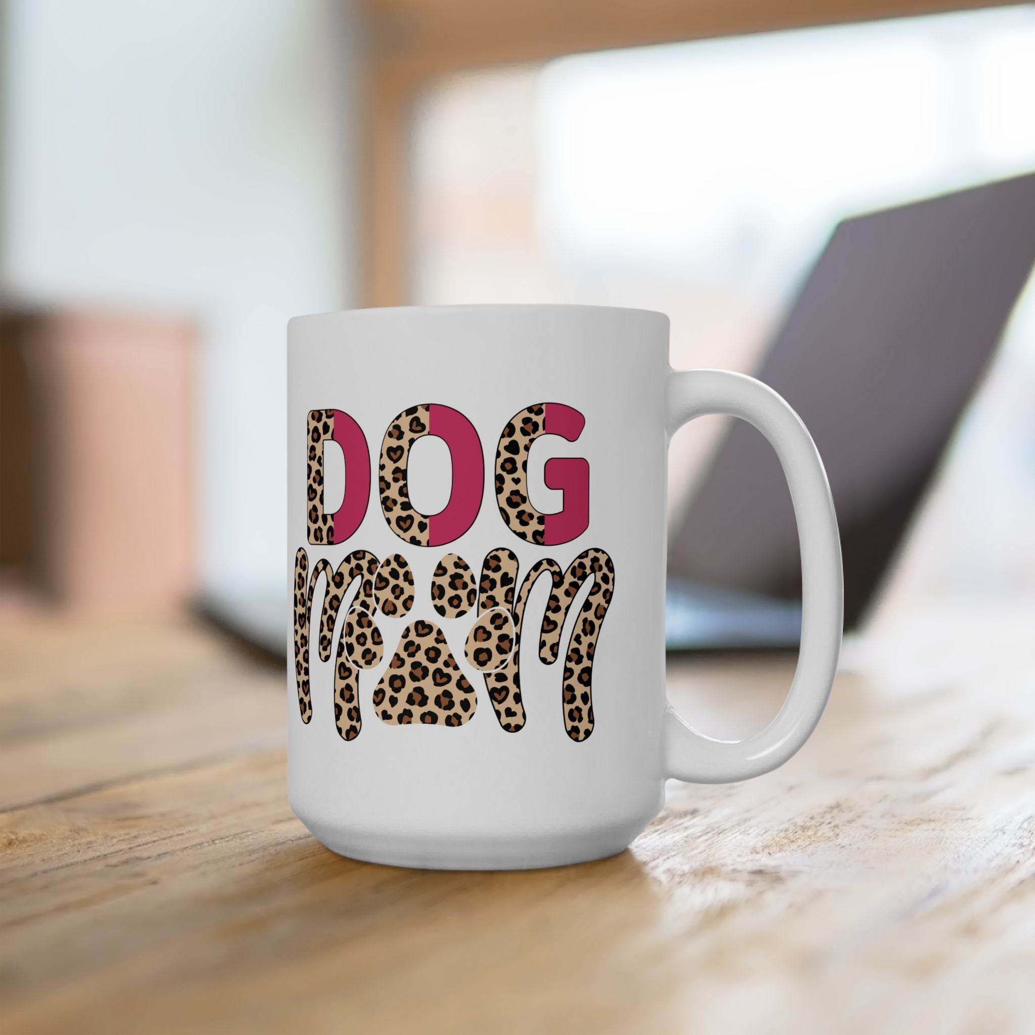 Printify white eco friendly ceramic dog mom mug with leopard print DOG MOM text and pink accents on wooden table