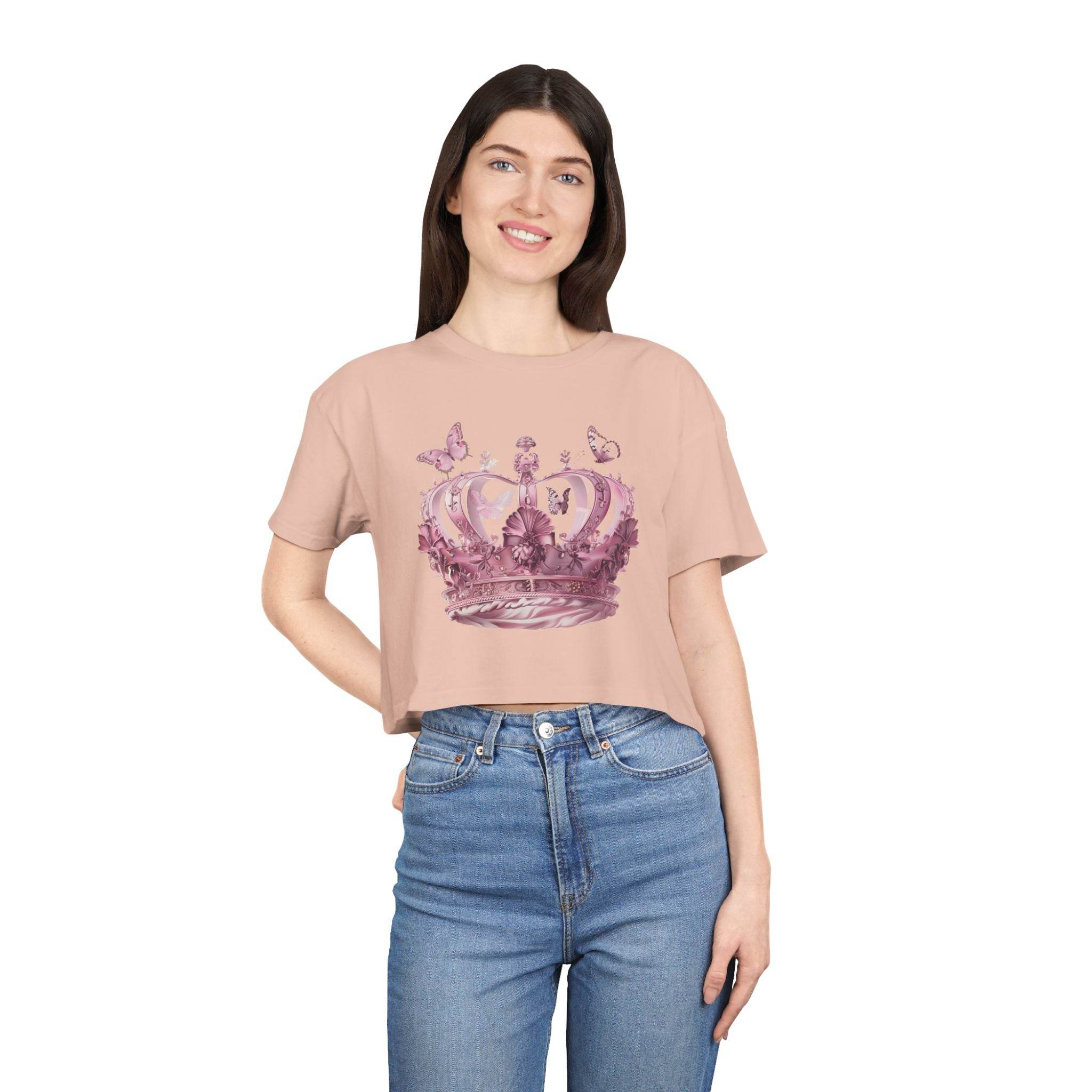 Woman wearing Petal & Crown eco crop shirt in light pink with crown and butterfly design