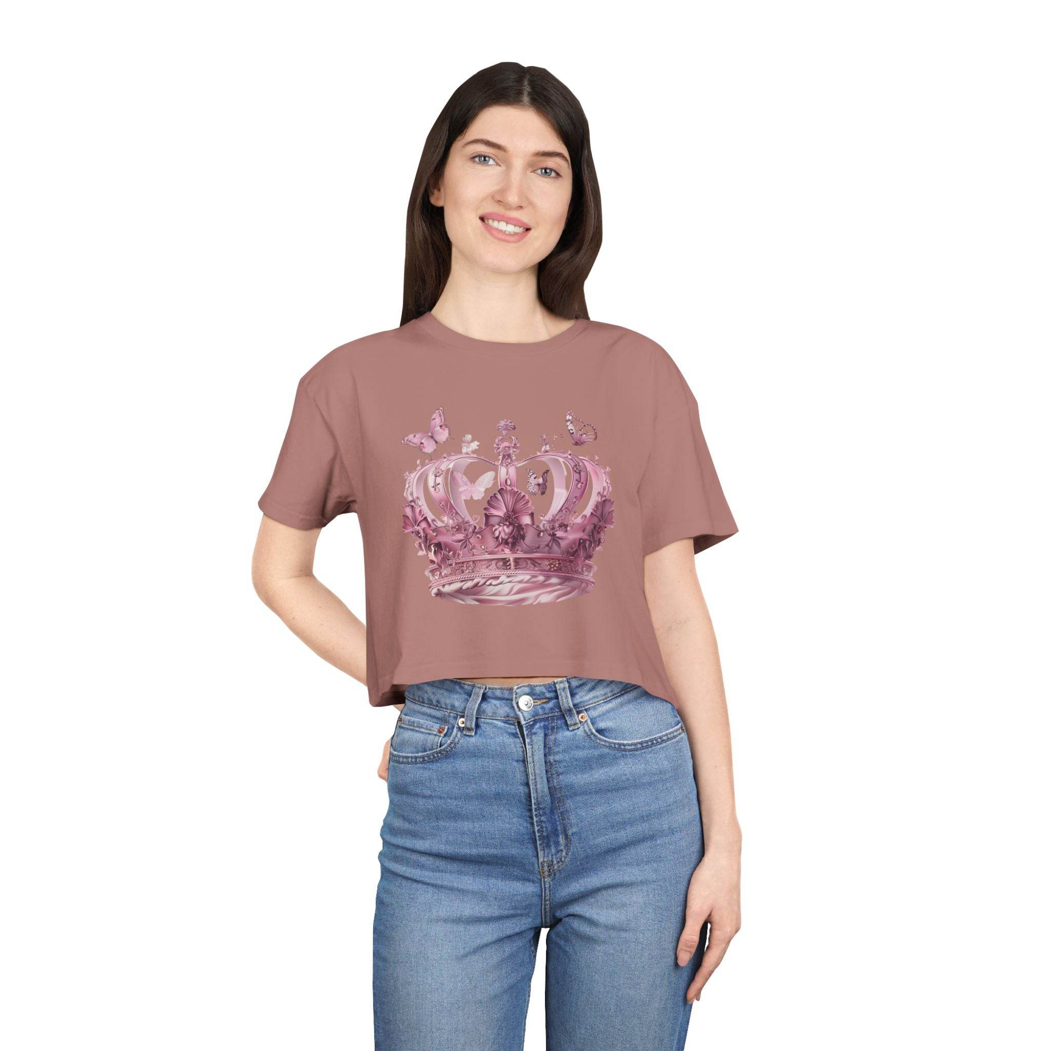 Woman wearing a Petal & Crown eco crop shirt in dusty rose with crown and butterfly design