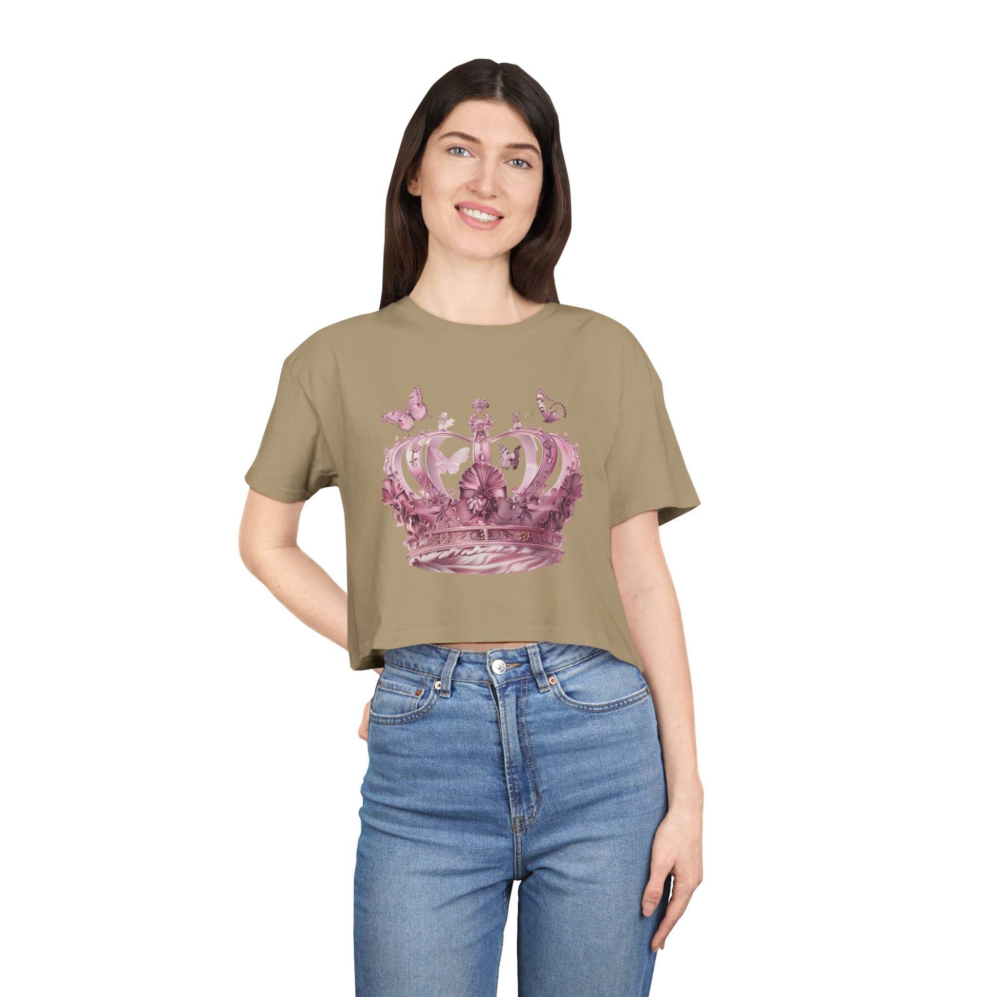 Woman wearing beige Petal & Crown eco crop shirt with pink crown graphic and butterflies