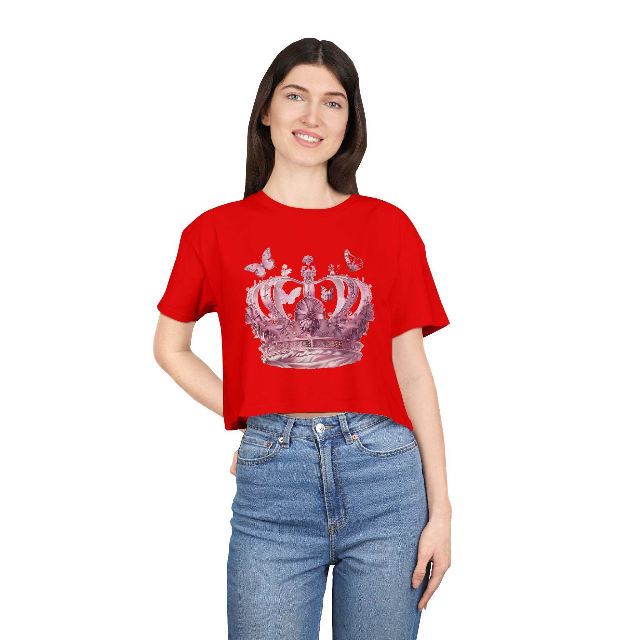 Woman wearing red Petal & Crown eco crop shirt with crown graphic and butterflies paired with blue jeans