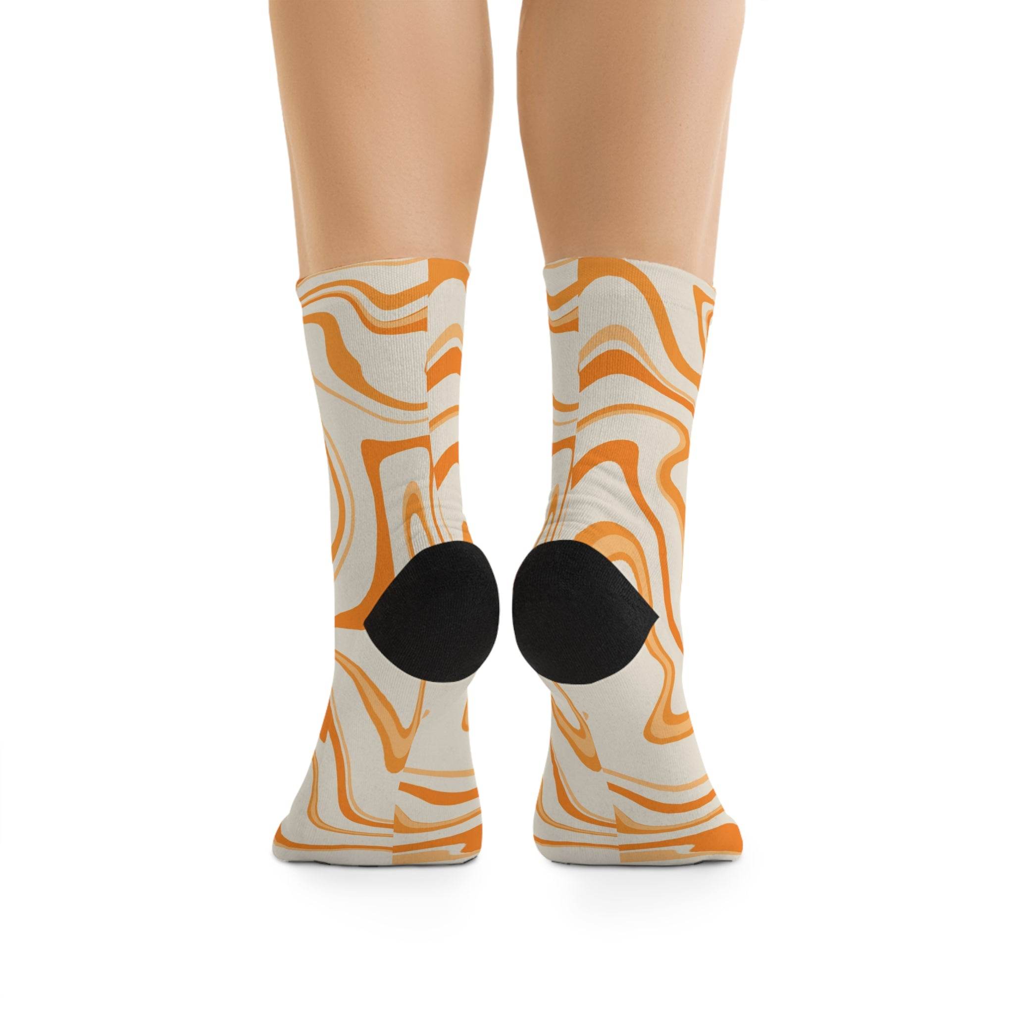 Printify recycled poly socks with orange and cream abstract swirl design and black heel patch