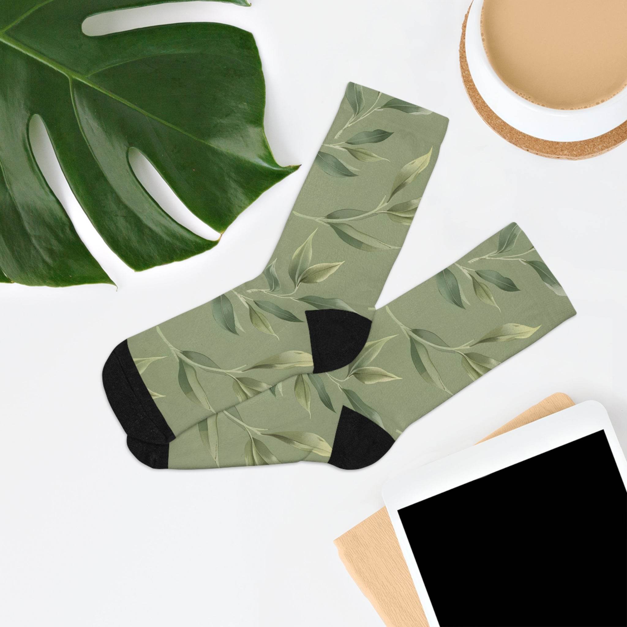 Printify recycled poly socks with green leaf pattern and black heel and toe on white background