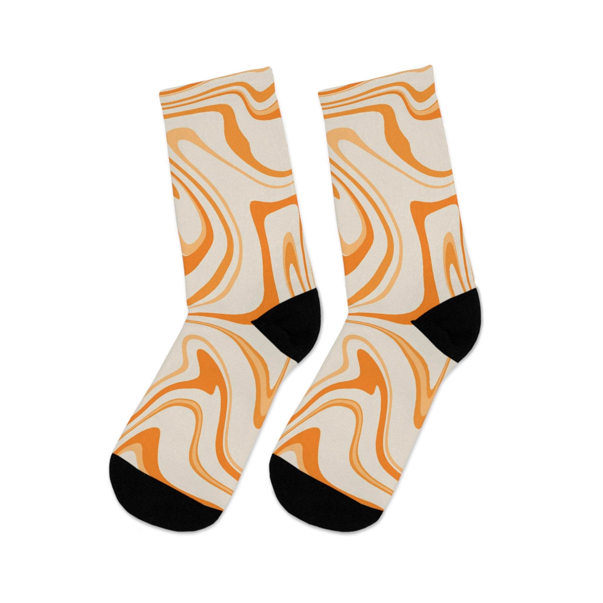 Printify recycled poly socks with abstract orange and beige swirl design and black heel and toe accents